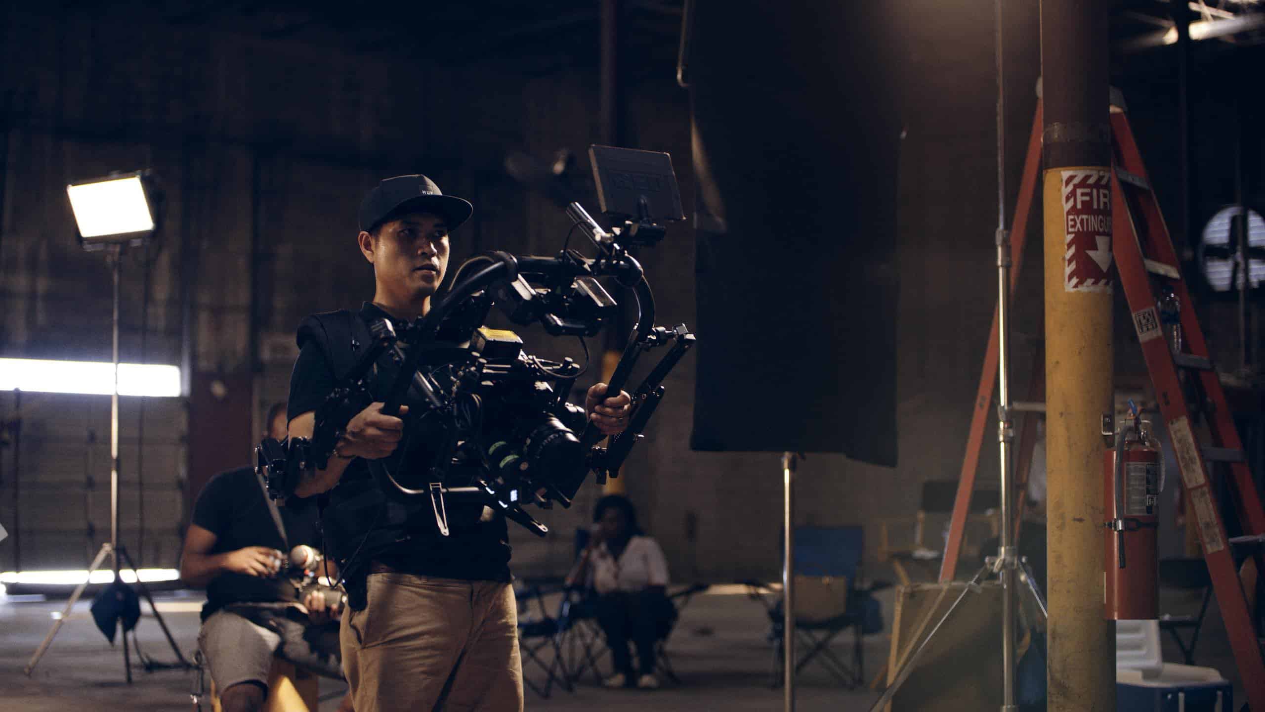 Tom using video equipment on a set in a studio