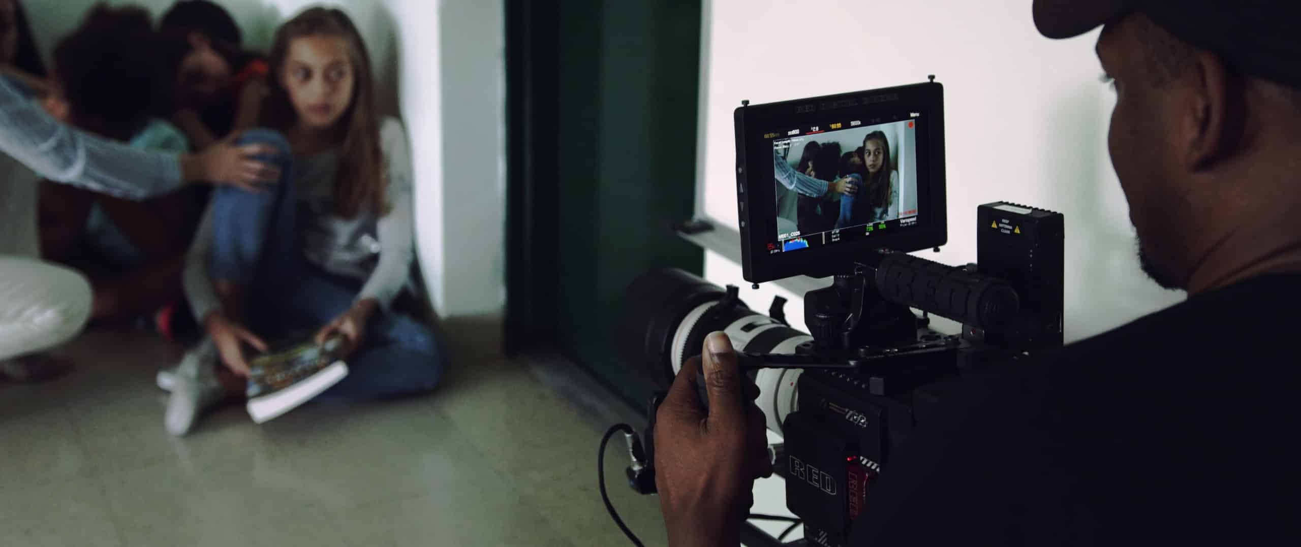 The Dailies Season 2 Episode 8 RED Cameras RED cameras with view from behind of crew member filming a group of children