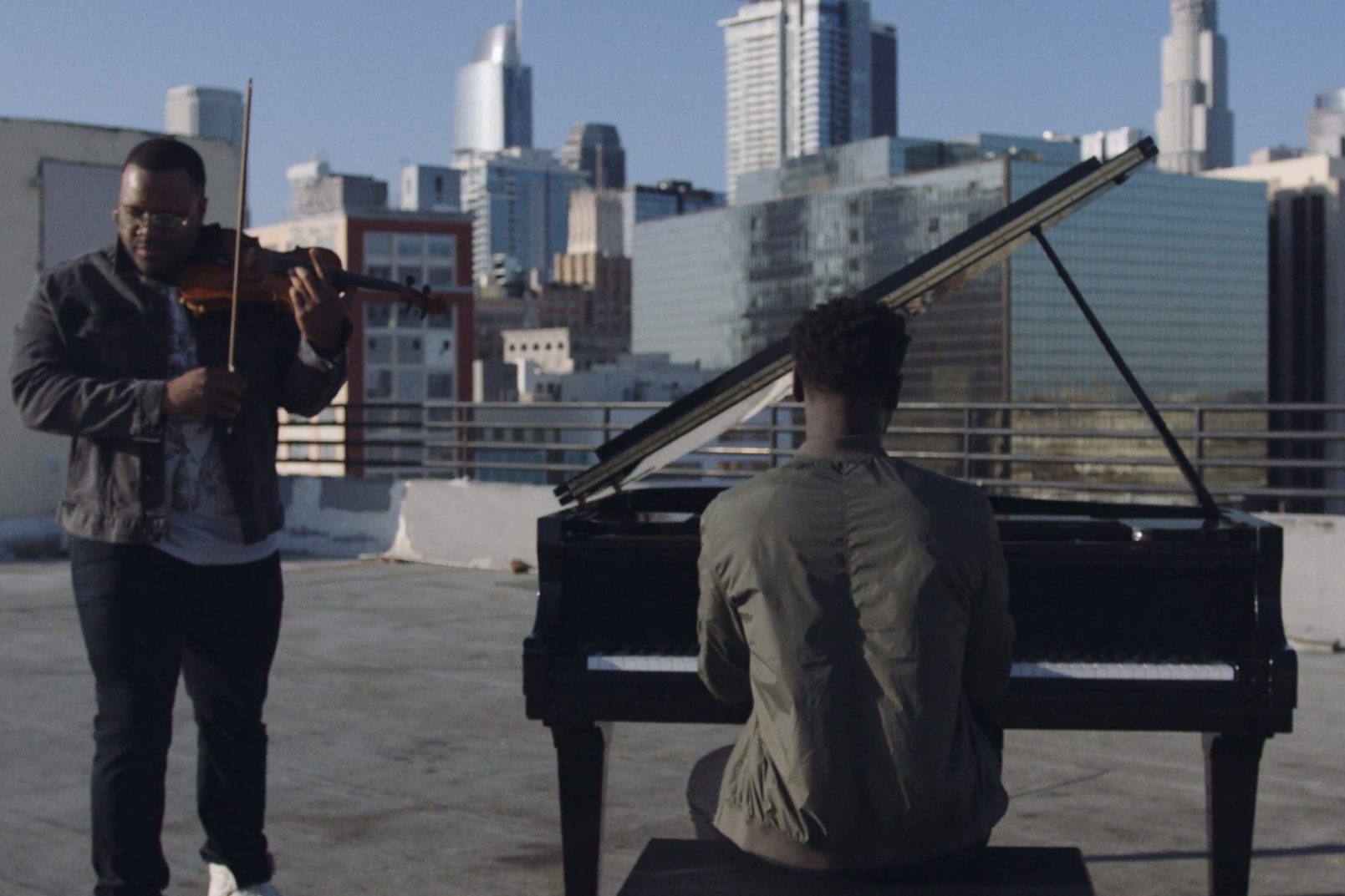 Production Resources Downtown LA Locations with two men on a rooftop with one playing a violin and the other playing a piano