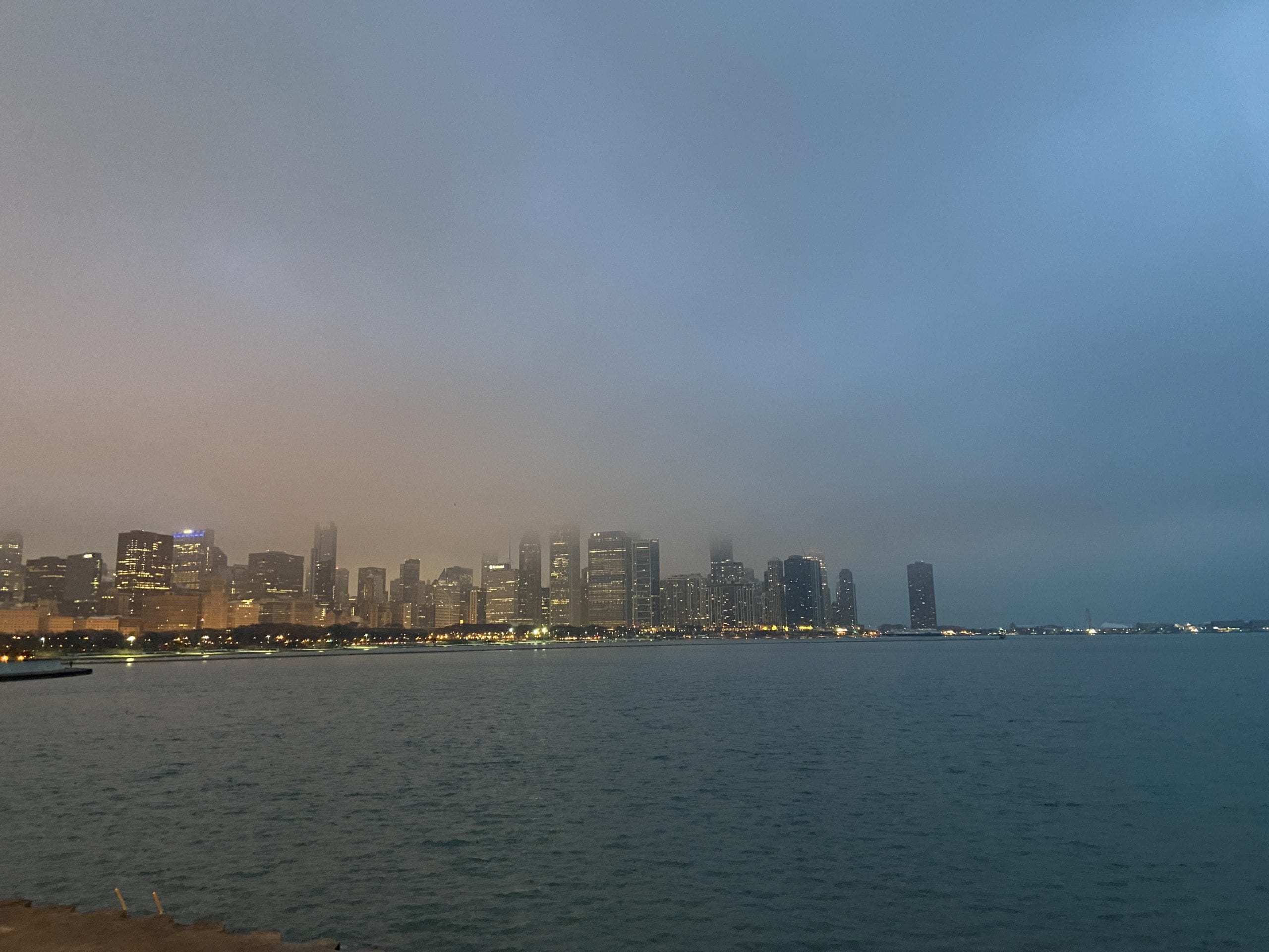 View of city by the water with fog