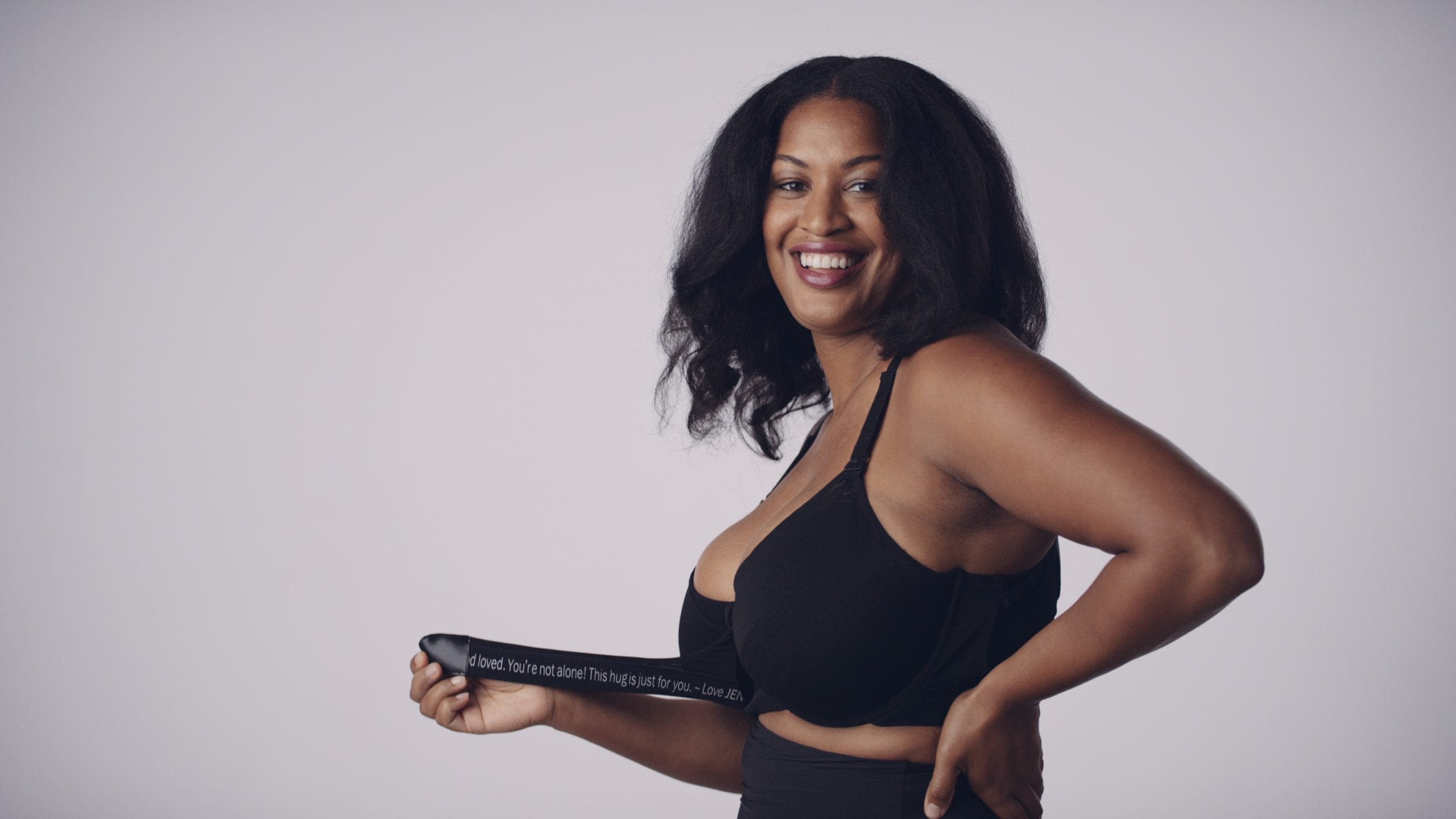 cis-page-jennabra33-1 JennaBra Youtube Preroll Woman Fort Lauderdale Side profile of model smiling with black hair wearing black bra and panties