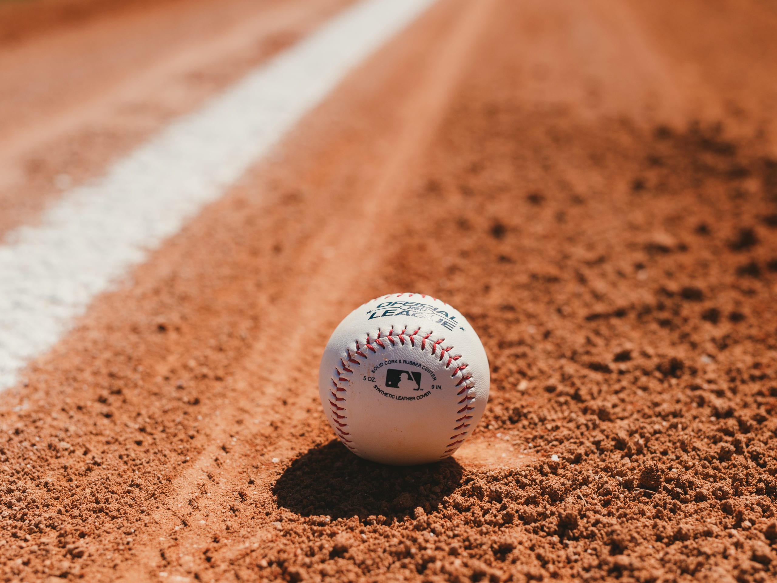 IU C&I Studios Portfolio Ball Cap Liner Closeup of baseball on the ground on a baseball field