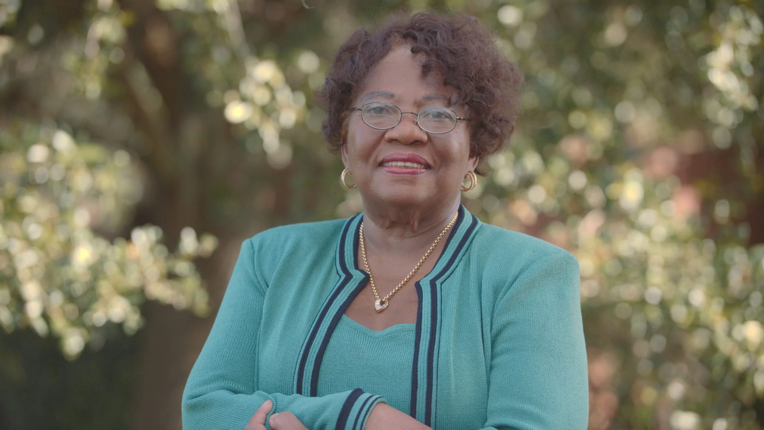 IU Geraldine Florida Campaign Turn Florida Blue Politics Headshot of her wearing teal blue and black outfit smiling for the camera