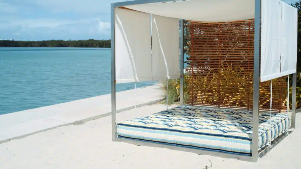 Beach bed with cushion and shades on display