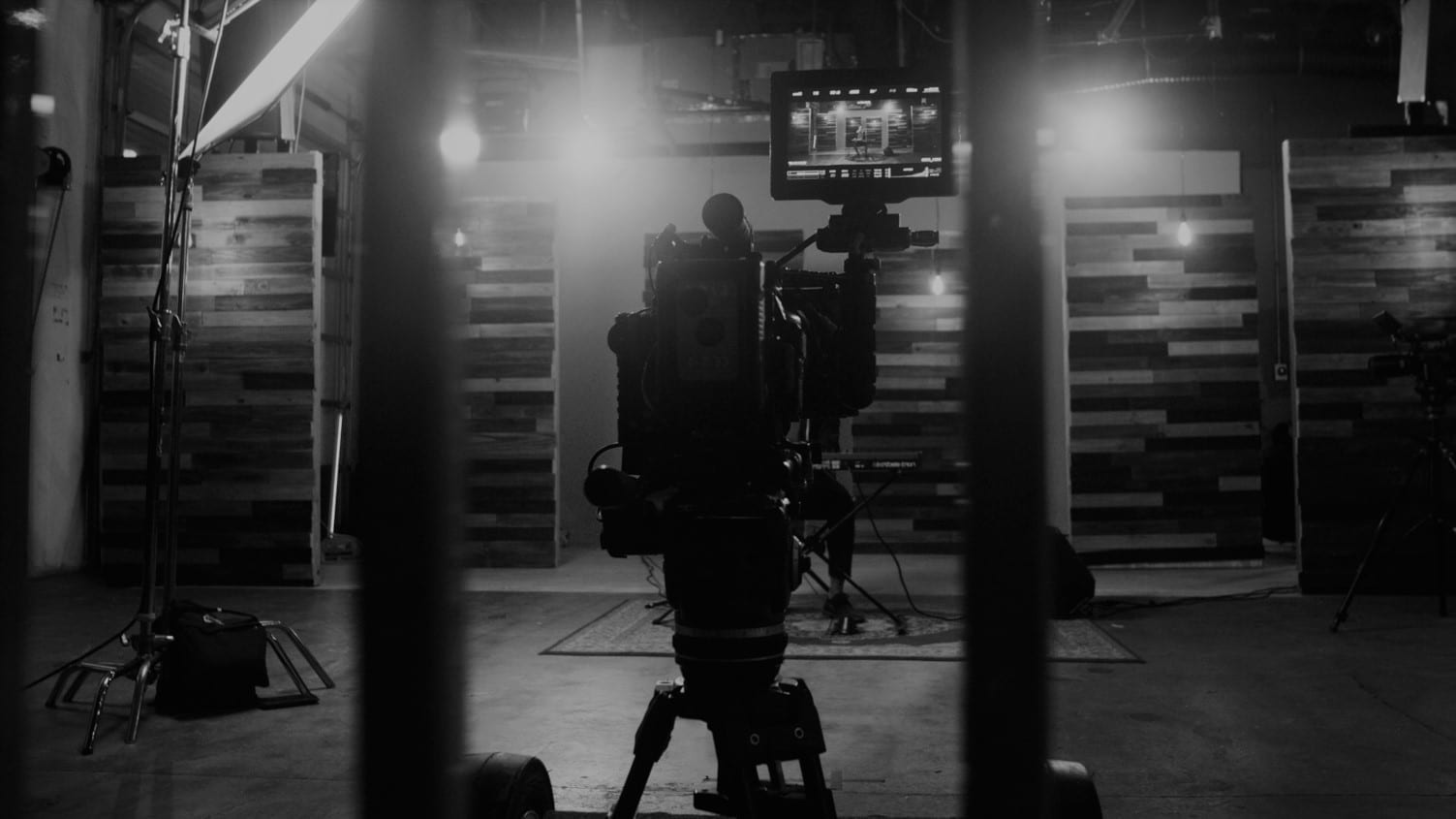 Black and white photo of lighting and video camera equipment on the set.