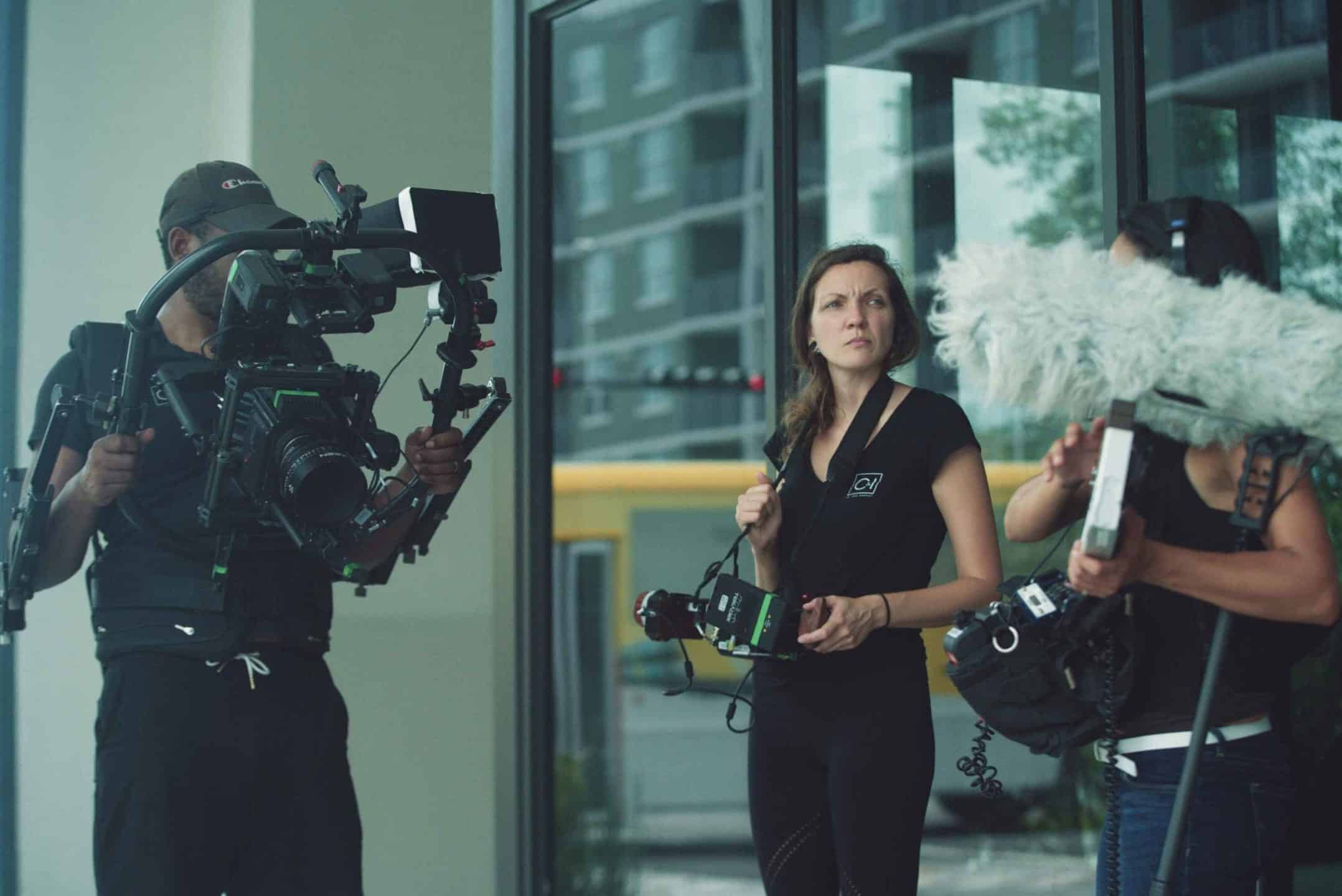 76 Words DMP Walk and Talk Test Advertising One male and two female staff members with video camera, camera and sound equipment respectively