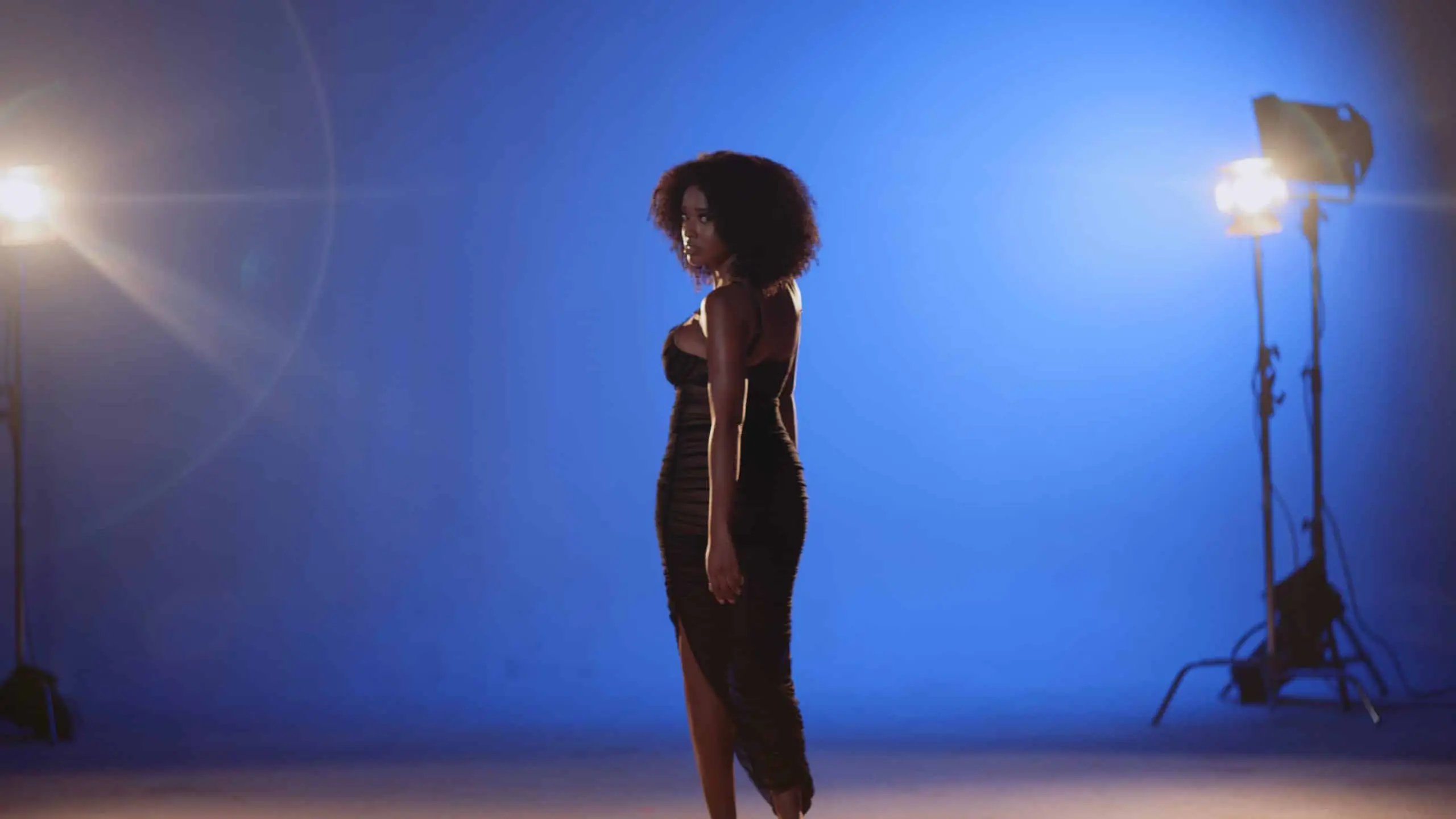 cis-page-all-dolled-up11 Side profile of model posing for the camera looking over her shoulder on a set in a studio