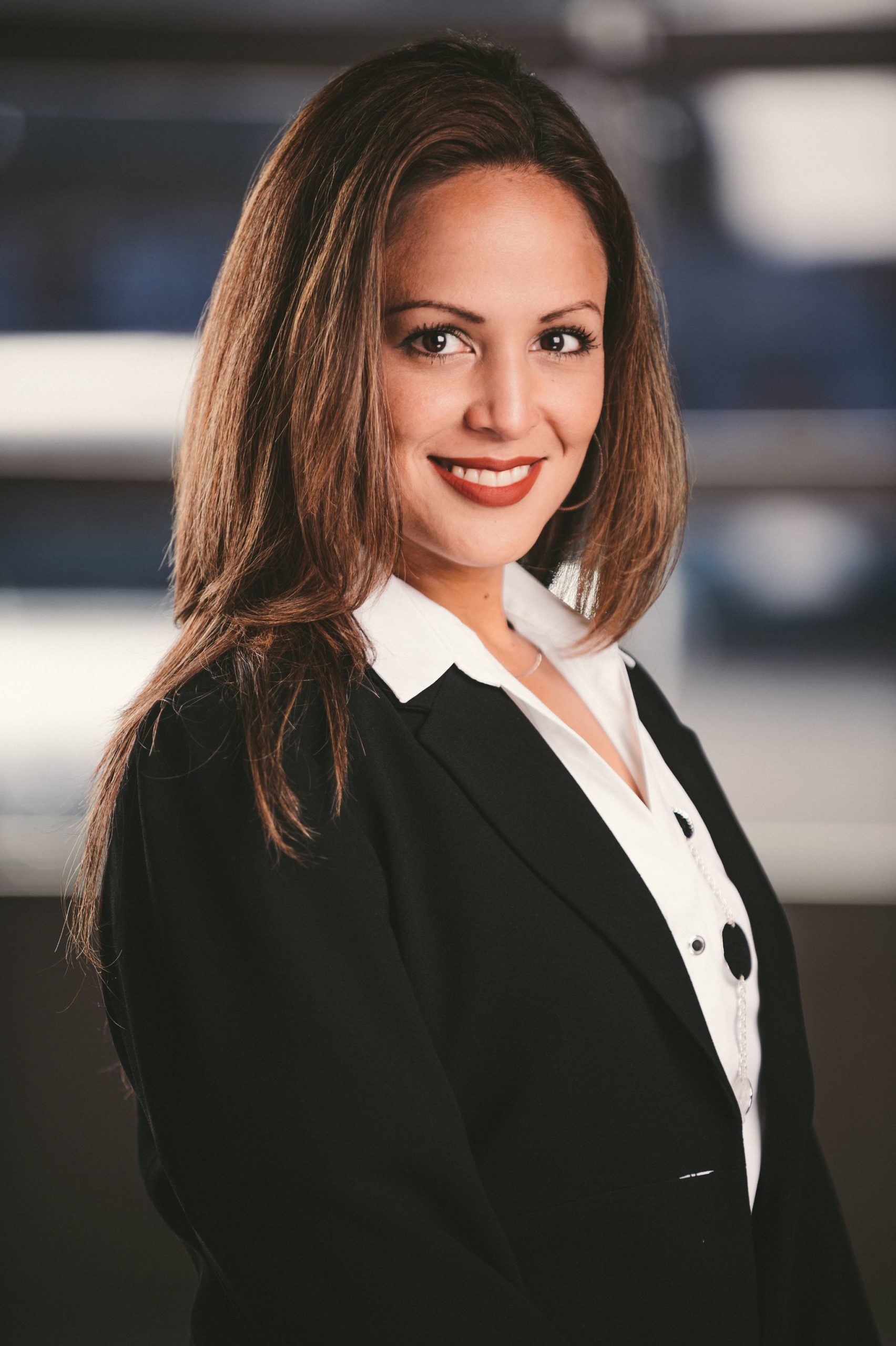 IU C&I Studios Portfolio Van Horn Law Group Head Shot of woman with long brown hair wearing a black dress jacket with white blouse