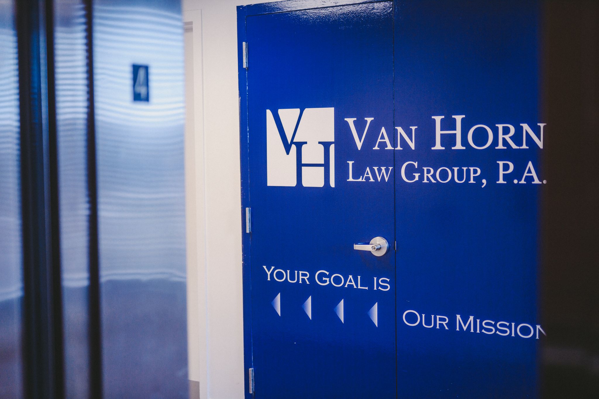 IU C&I Studios Portfolio Van Horn Media Day Closeup of blue doors with white law firm logo and motto on it