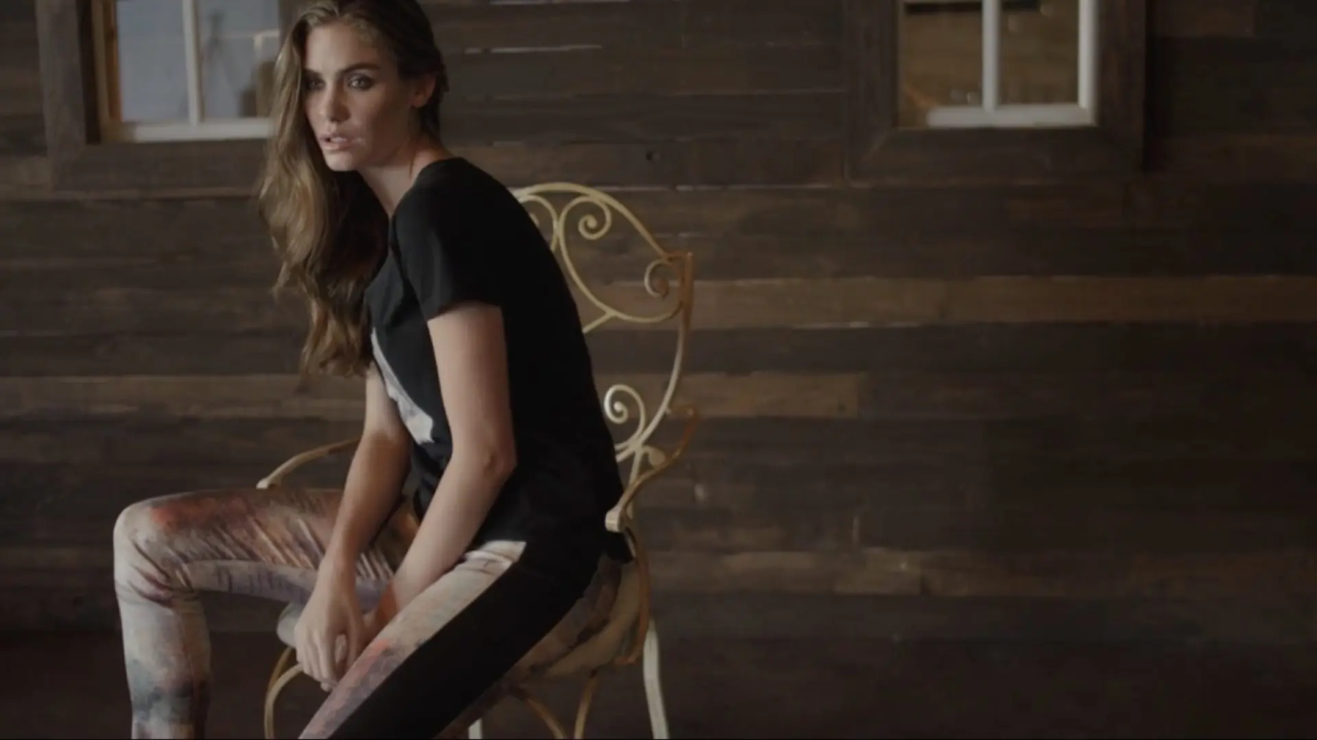 FIGI Jeans 3 Side profile of model posing on chair