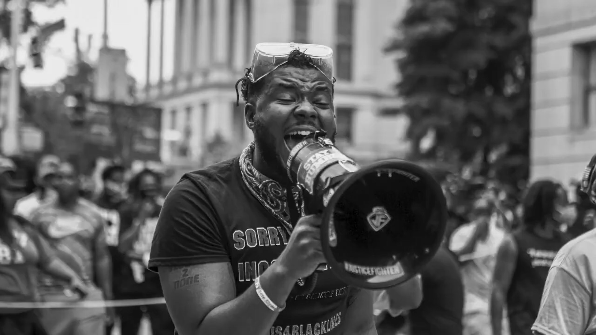 Black and white of man using a bullhorn. political campaign