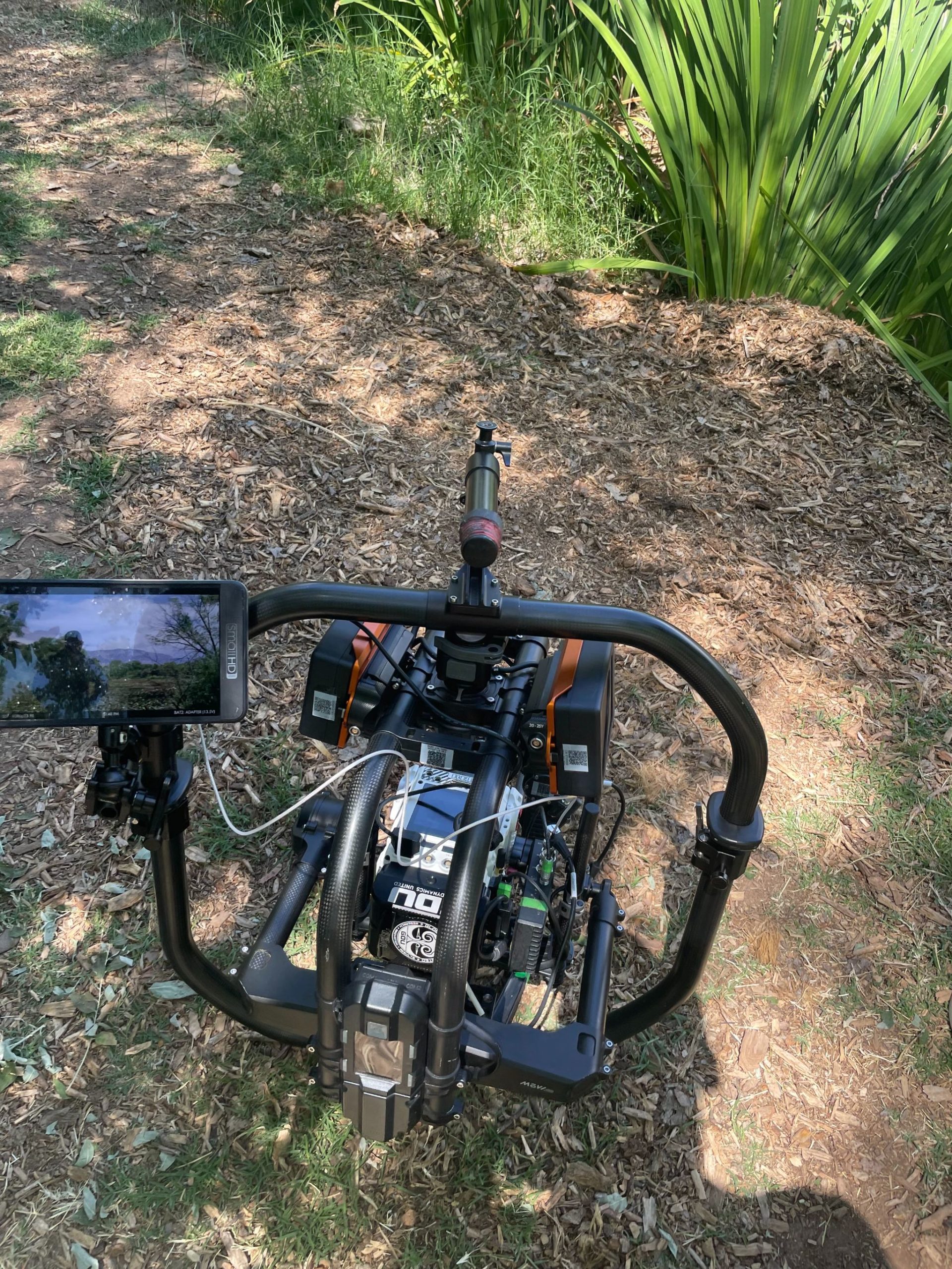 IU C&I Studios Portfolio Closeup of videographer equipment on the ground by green foliage