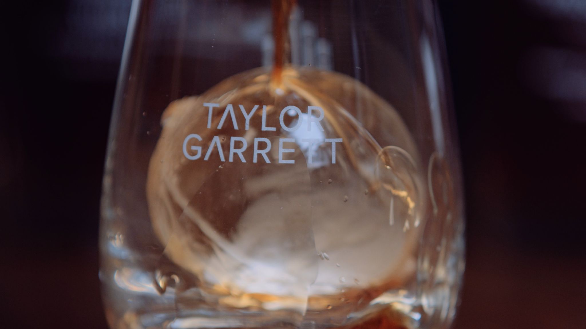 IU C&I Studios Portfolio Taylor Garrett Spirits Closeup of whiskey being poured into a glass