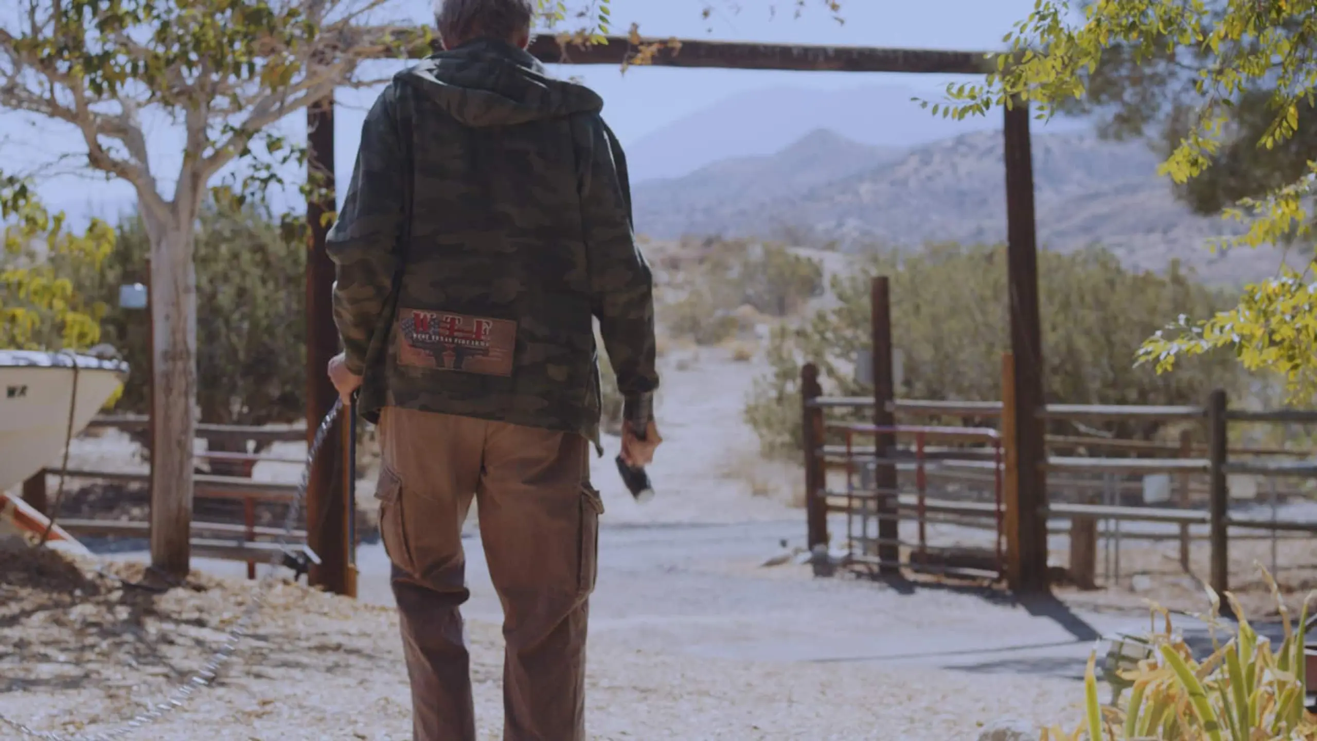 Bart McCarthy - Q Guy 10 View from behind of man walking through a ranch property