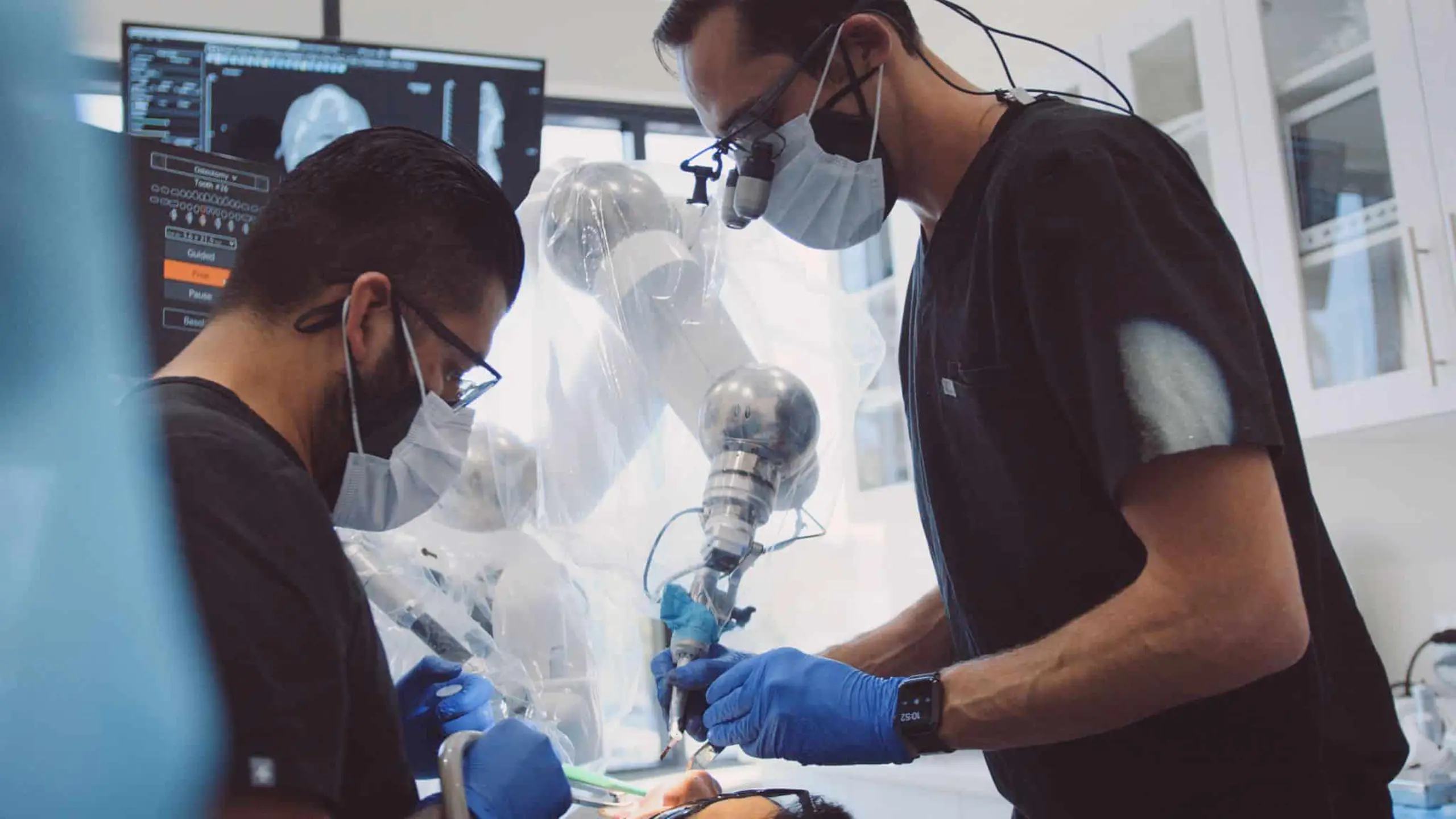 Pierce Aesthetics 12 Male dentist using Vomi equipment on patient while assistant looks on