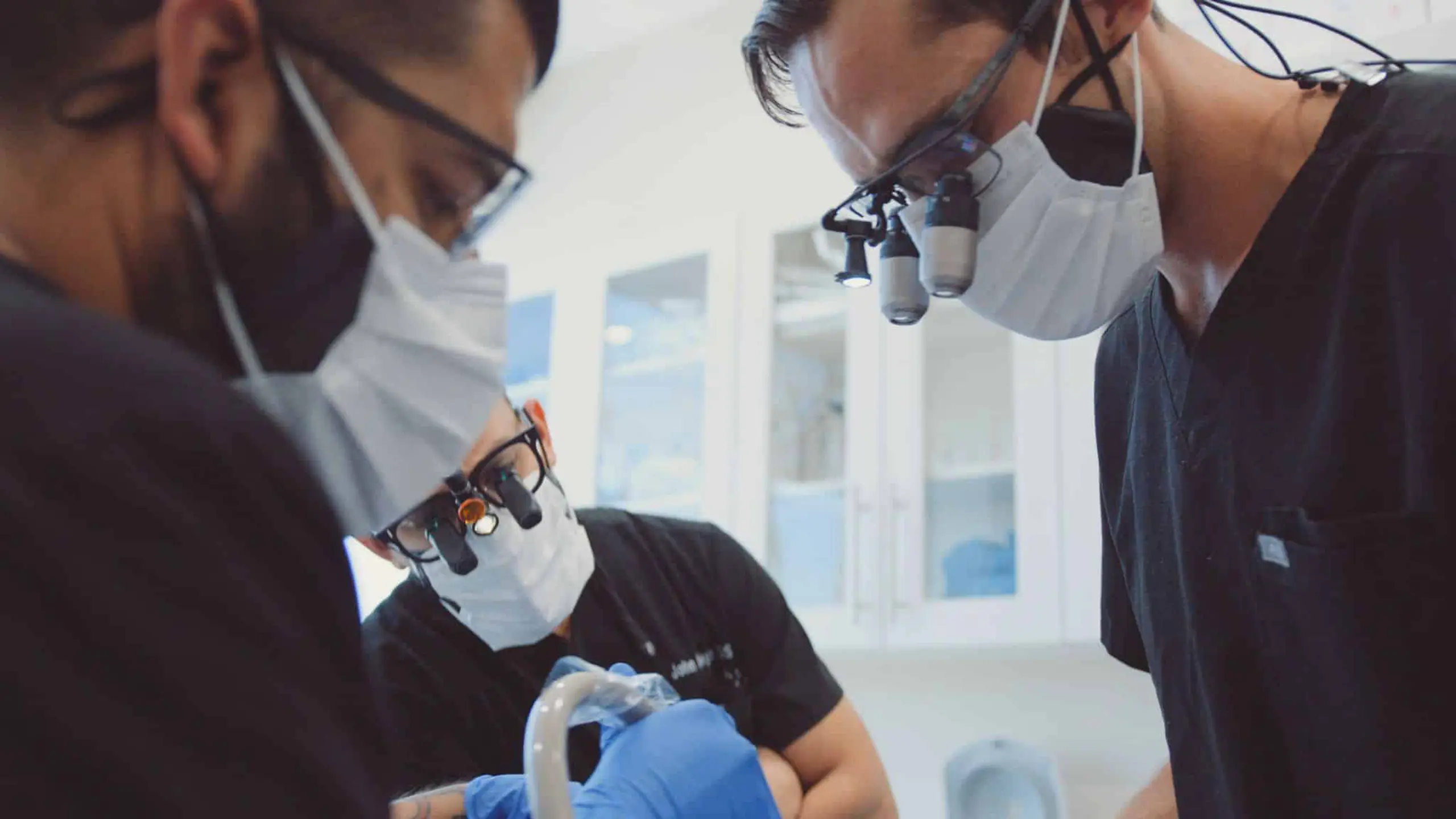 Pierce Aesthetics 13 Two male dentists and a male assistant working on patient