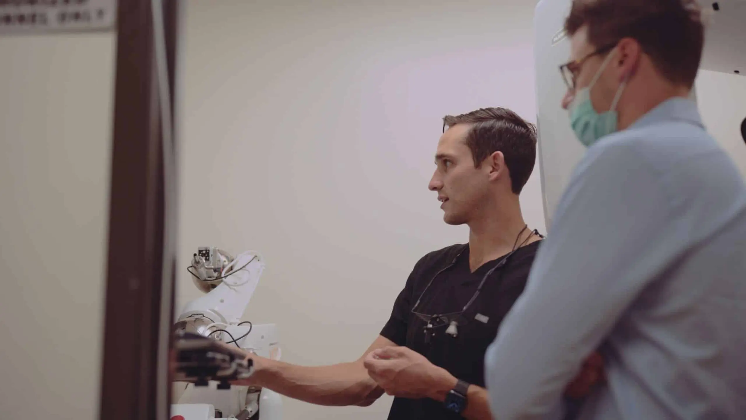 Pierce Aesthetics 14 Side profile of male dentist and assistant talking about something