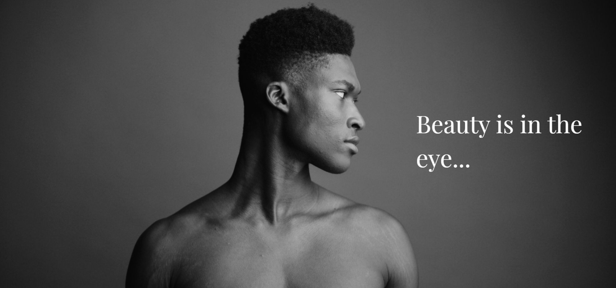 IU C&I Studios Portfolio and Page Beauty Featured Image Black and white headshot of bare chested male model looking off to the side with white Beauty is in the eye text