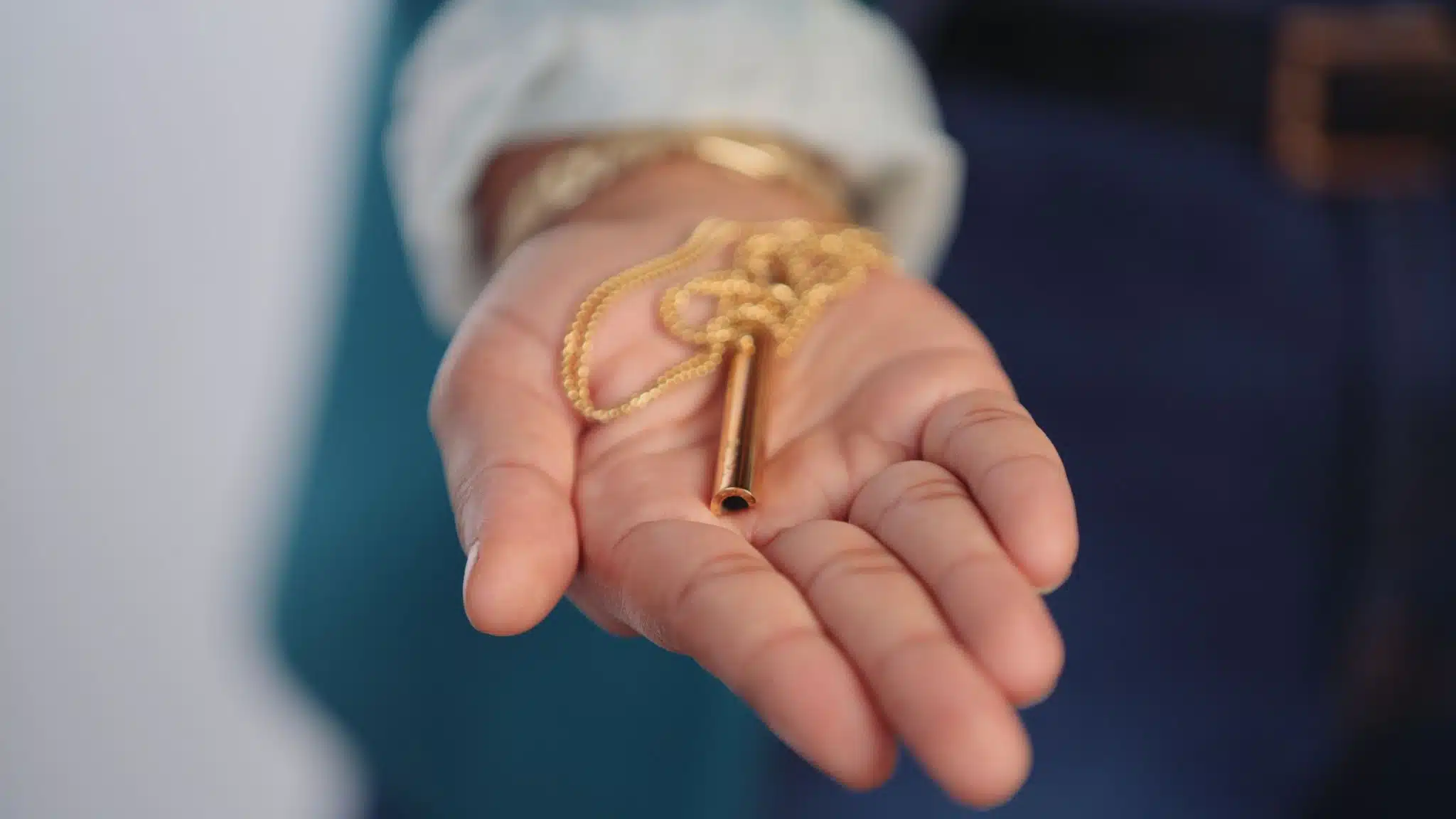 Tips for Product Photography Closeup of gold colored whistle in palm of hand