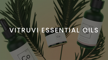 VITRUVI ESSENTIAL OILS Featured Image With White Logo On Backdrop Of Cream, Drop And Spray Containers With Herbs