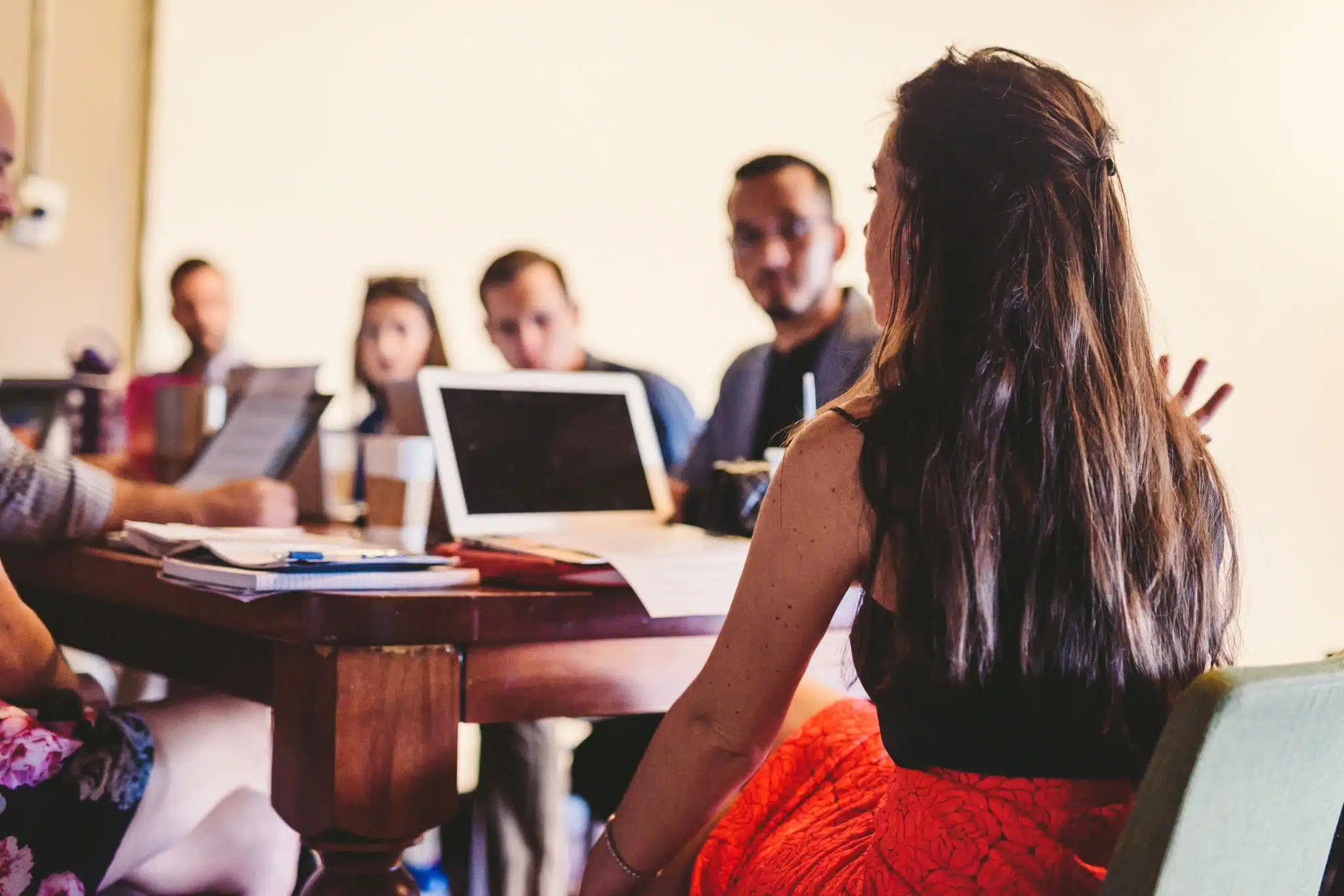 What is a Successful Video Marketing Strategy Woman with a laptop talking to people in a conference room