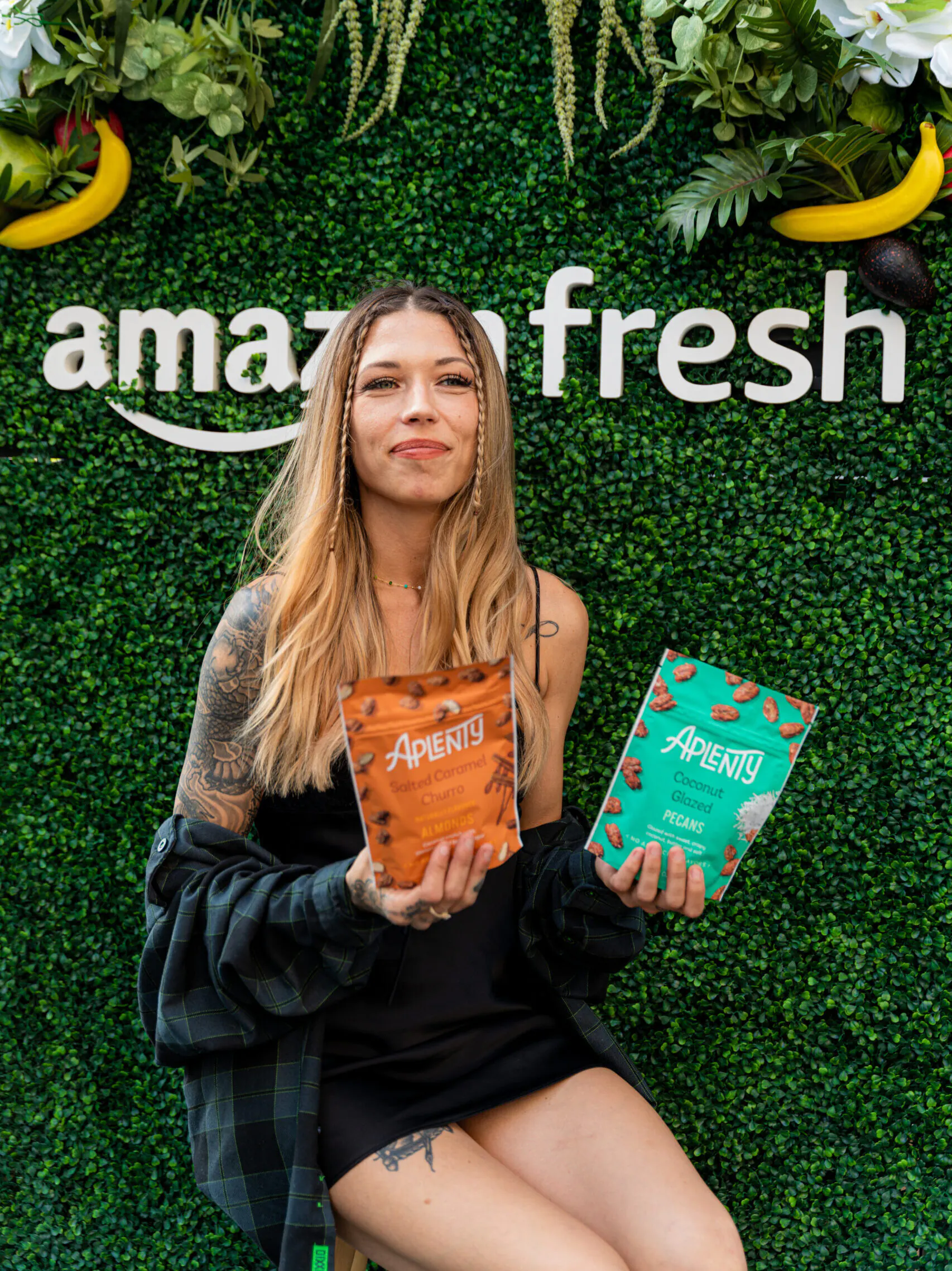 Pierce Promotions 45 Woman posing holding two bags of nuts smiling for camera