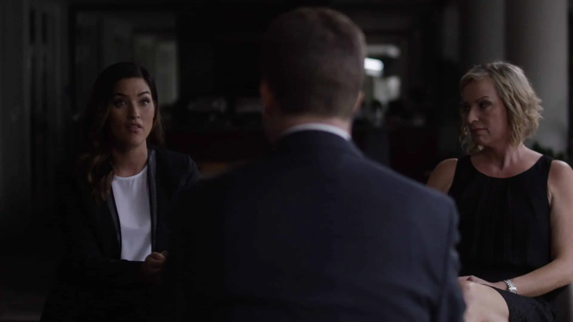 Man talking to two women