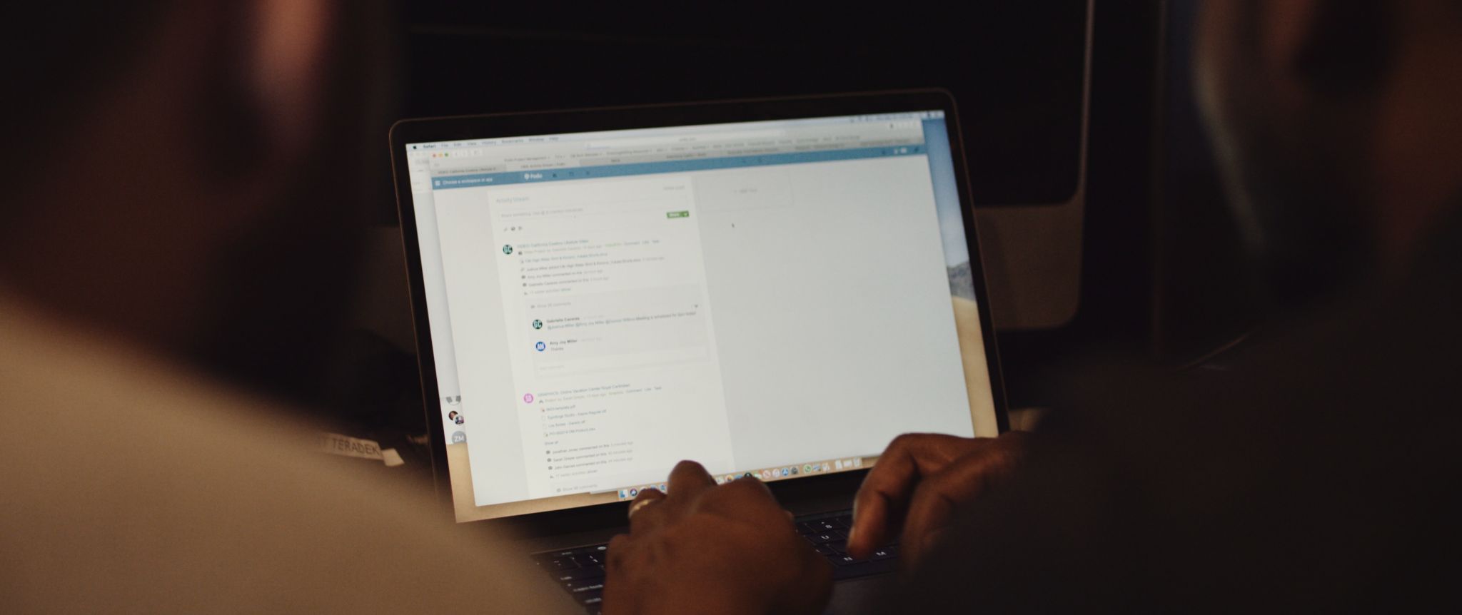 View over shoulder of man using a laptop