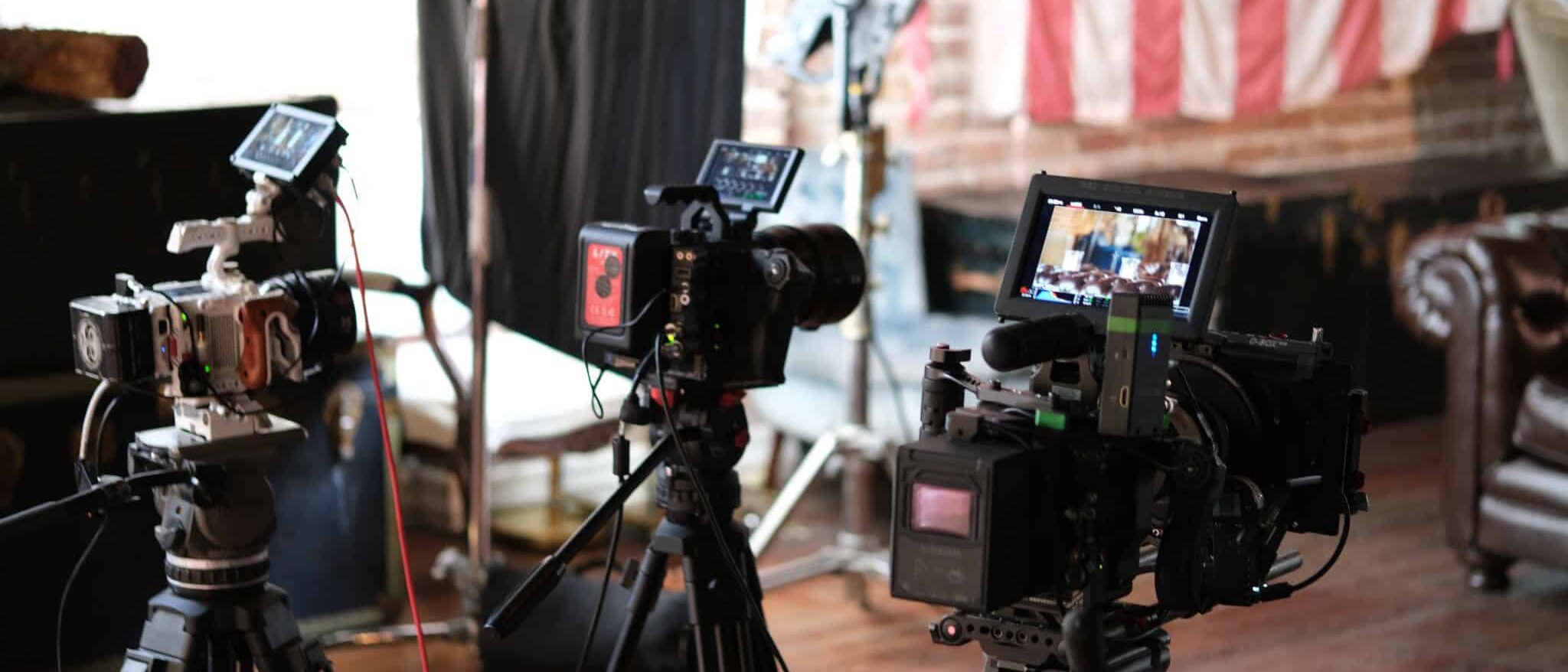 Pros and Cons of Marketing in the Metaverse Fund Black Tech Fritz View from behind of three video cameras on display on a set