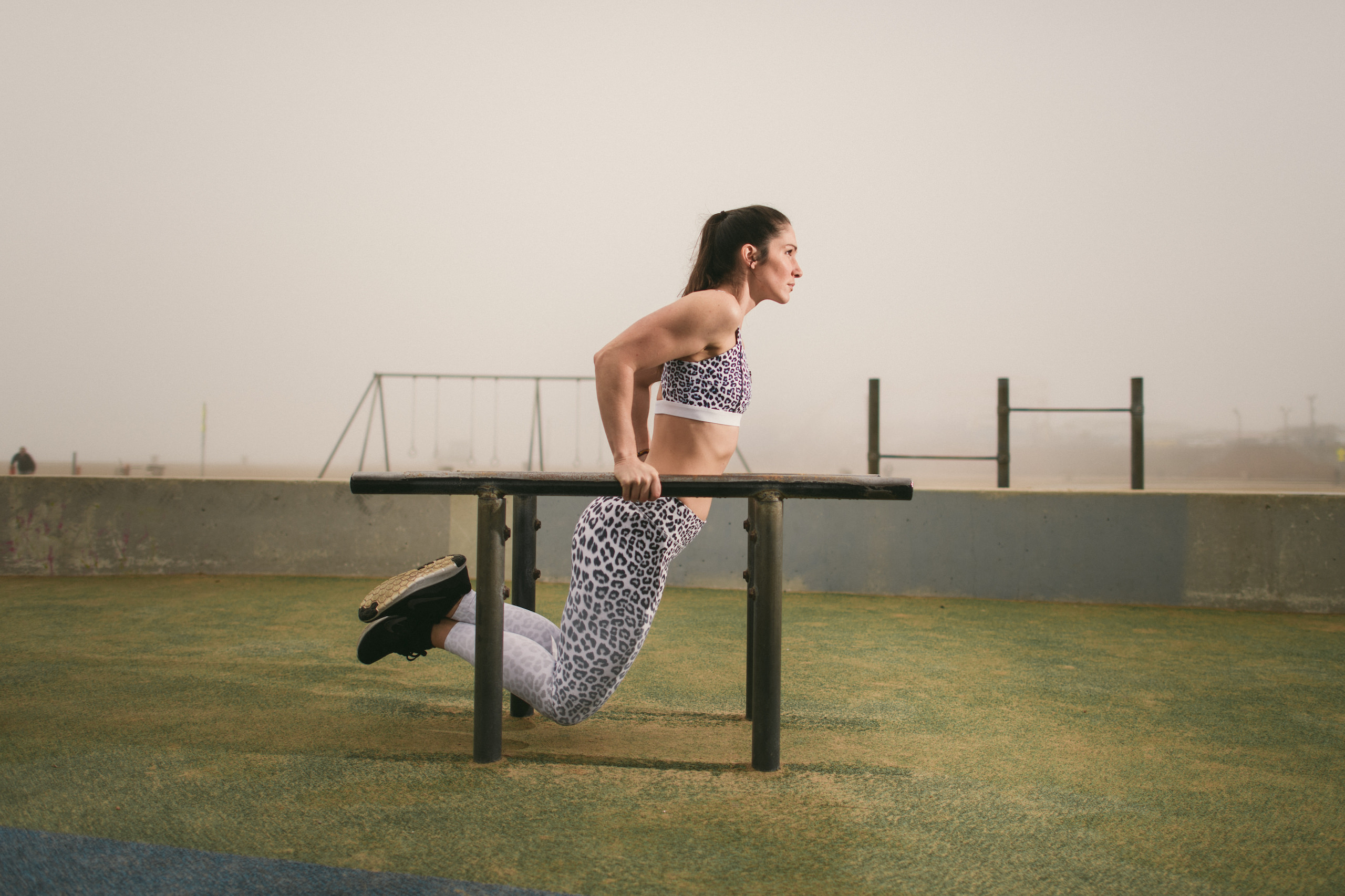 Health and Fitness Marketing JSM Woman using metal parallel bars
