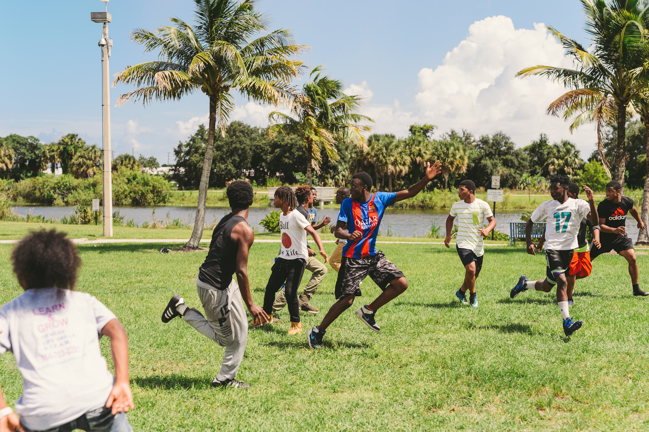 KES Group of young adults playing a sport in a field