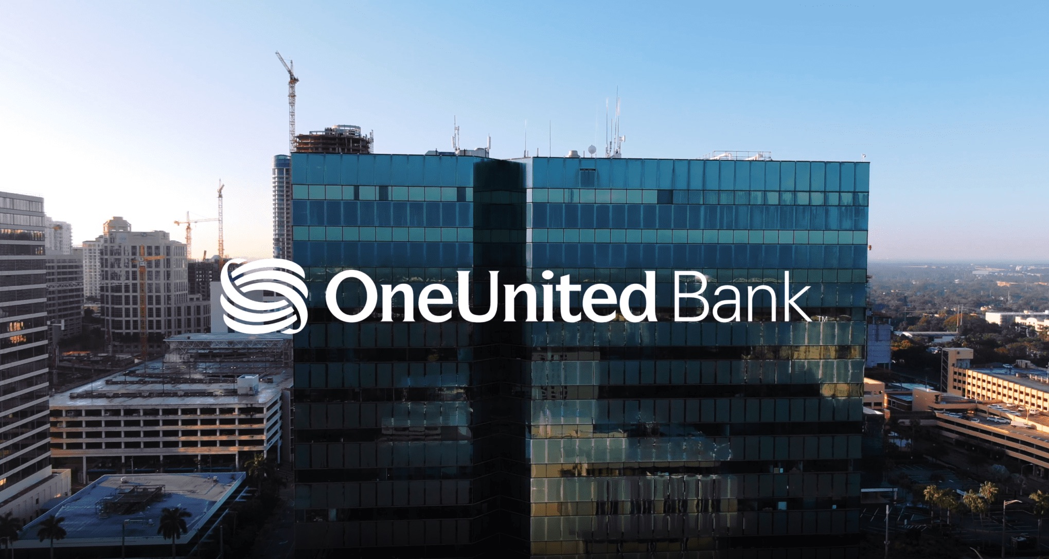 Audio Services by C&I Studios White One United Bank logo against a backdrop of building in the city