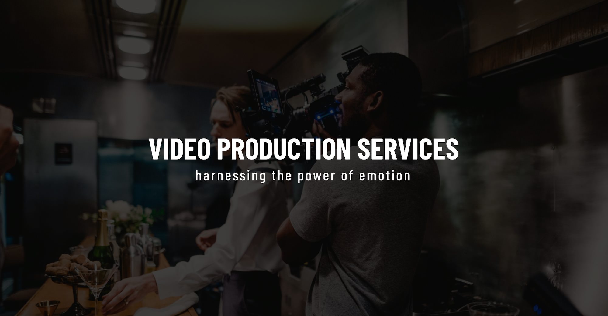 White Video Production Services title Creative Marketing Services by C&I Studios on dimmed background side profile of videographer filming bartender in a train car