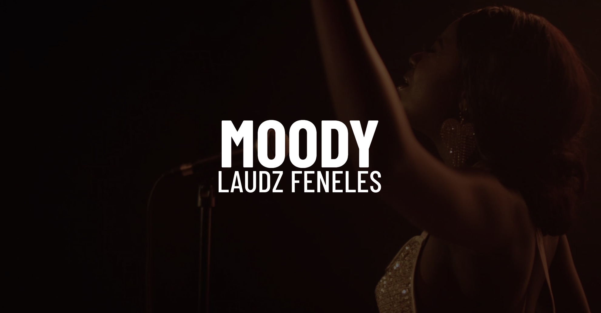 White Moody Laudz Feneles title on background headshot of her singing with arm in the air