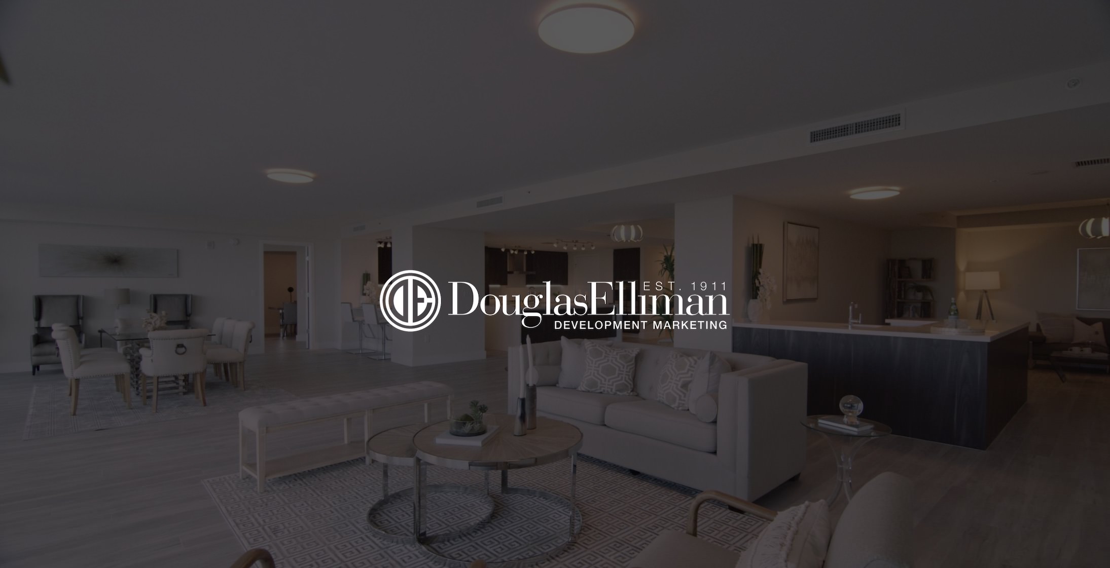 White Douglas Elliman Development Marketing title Truly Great Homes on dimmed background of interior of a house