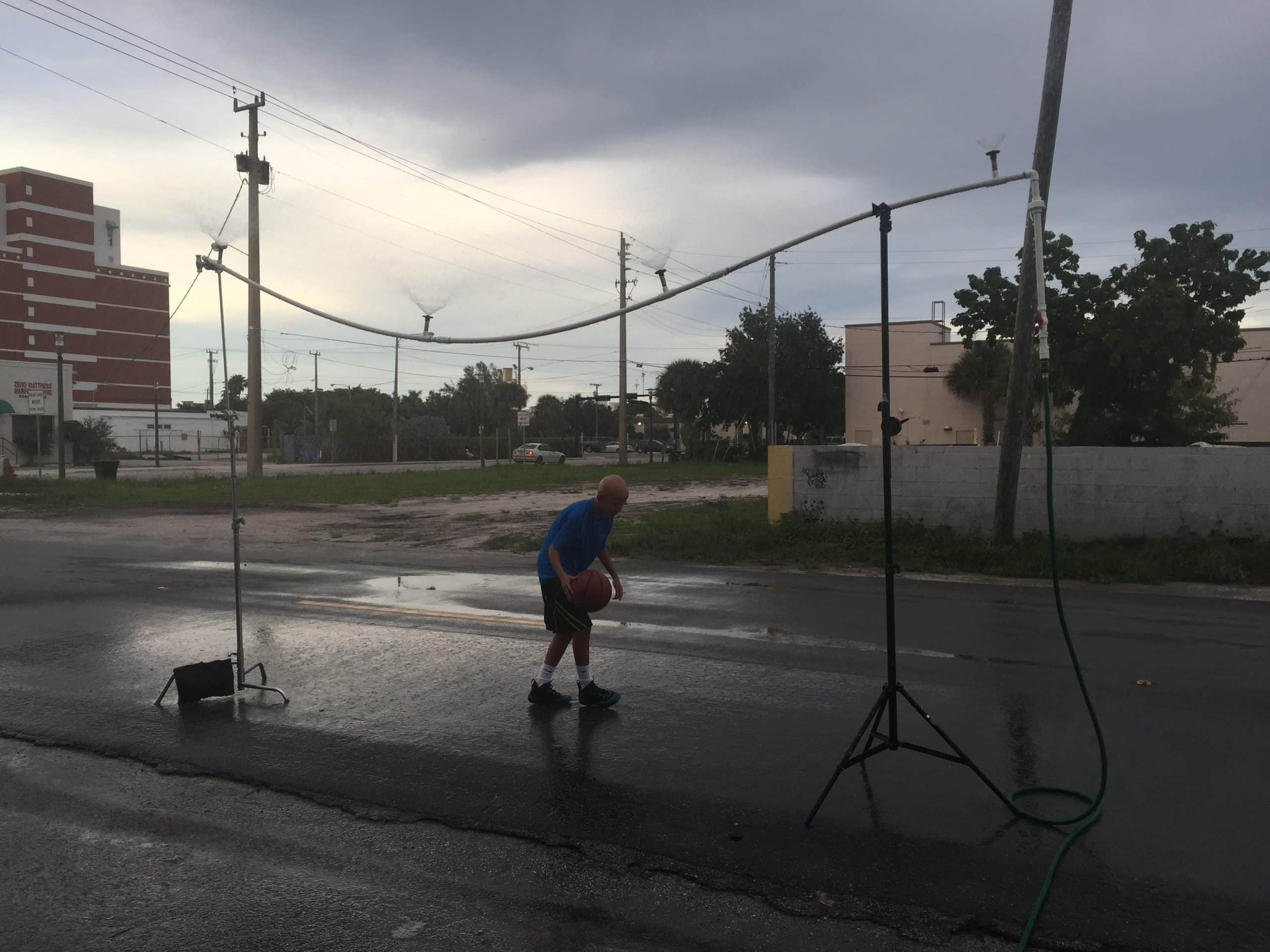 Charlie V What is Alopecia? Bald man dribbling a basketball on set outside the studios