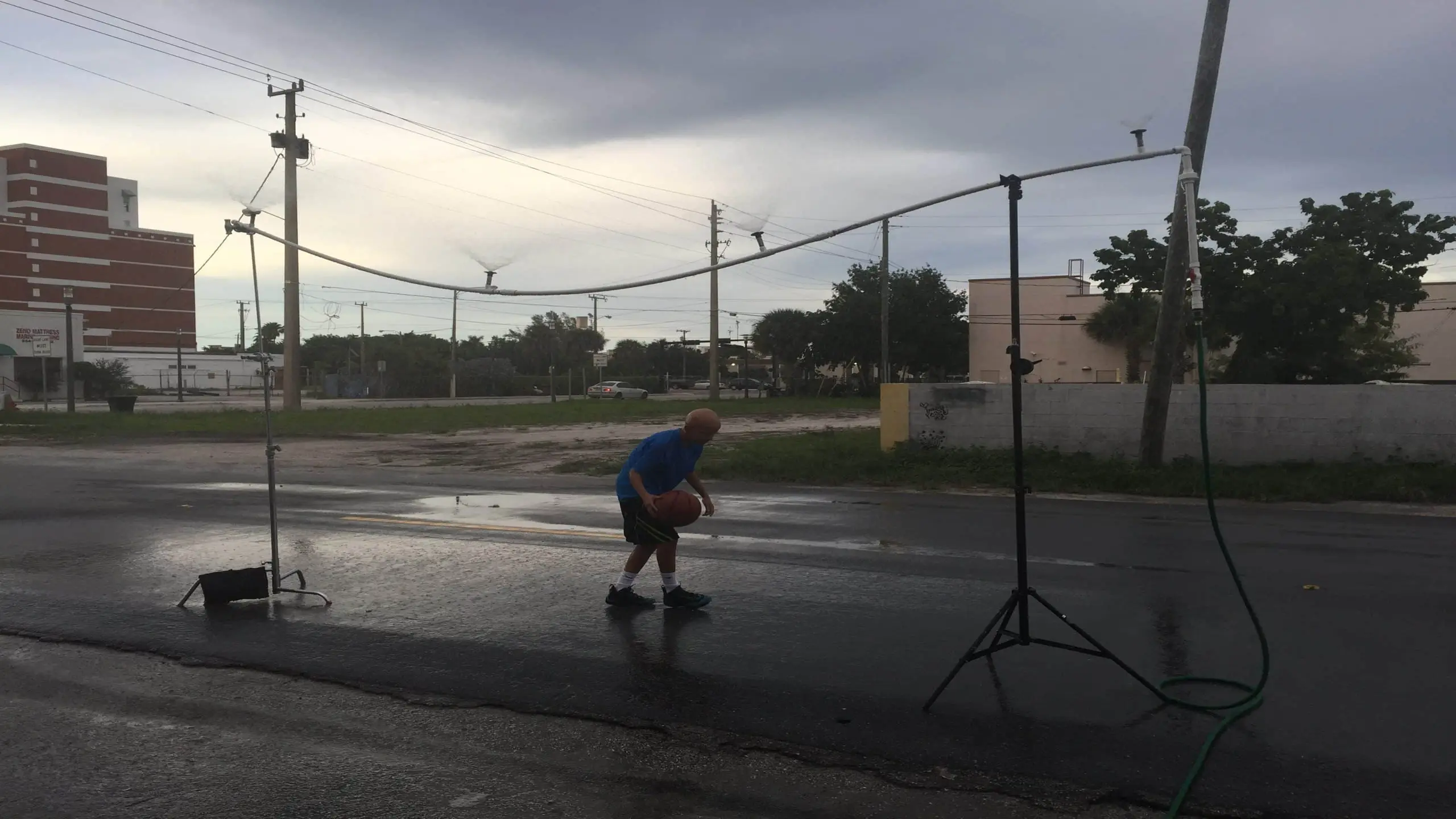 cis-page-what-is-alopecia9 Bald man dribbling a basketball on set outside the studios