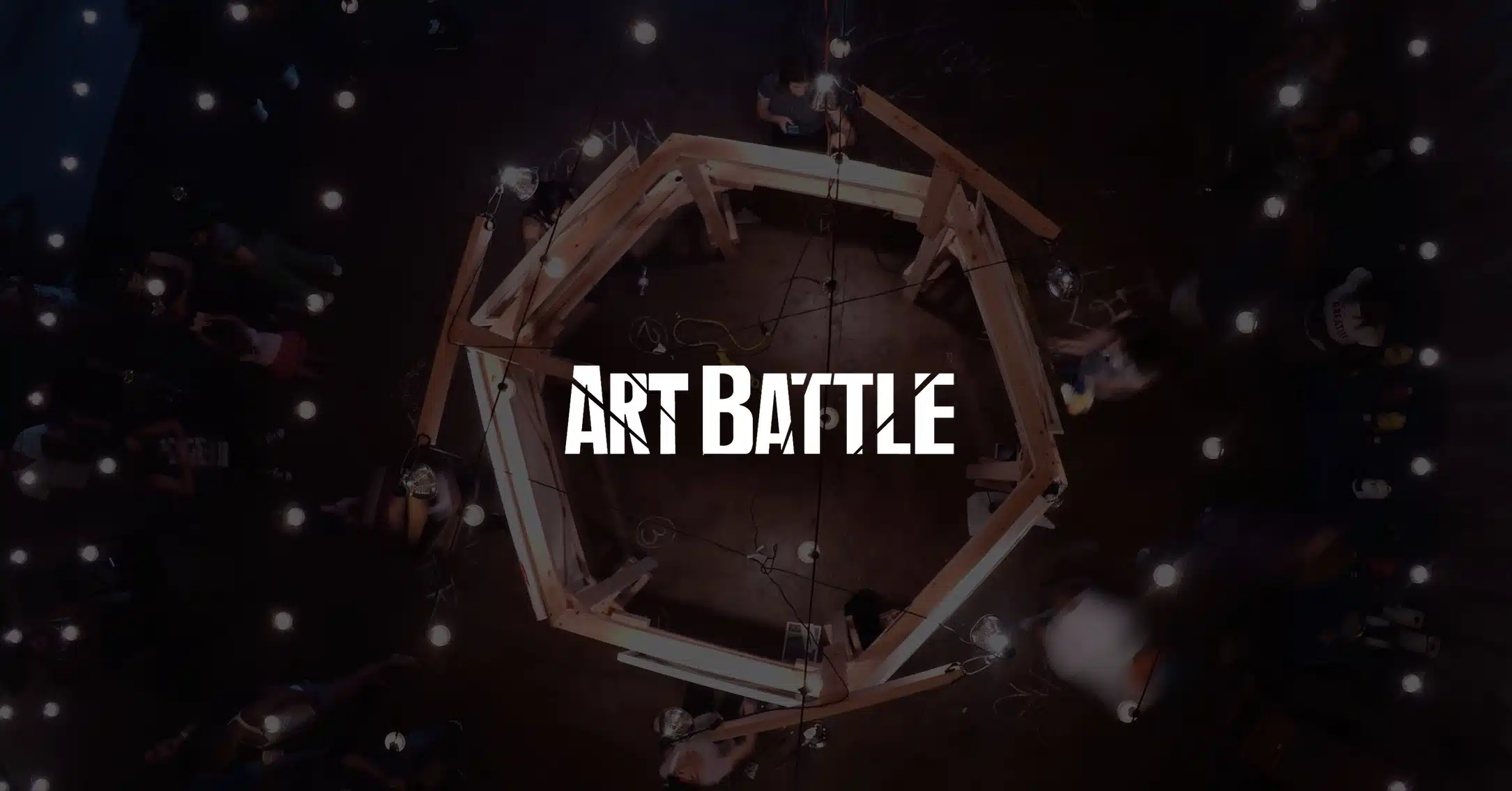 IU C&I Studios Page White Art Battle logo on dimmed background aerial of live painting competition