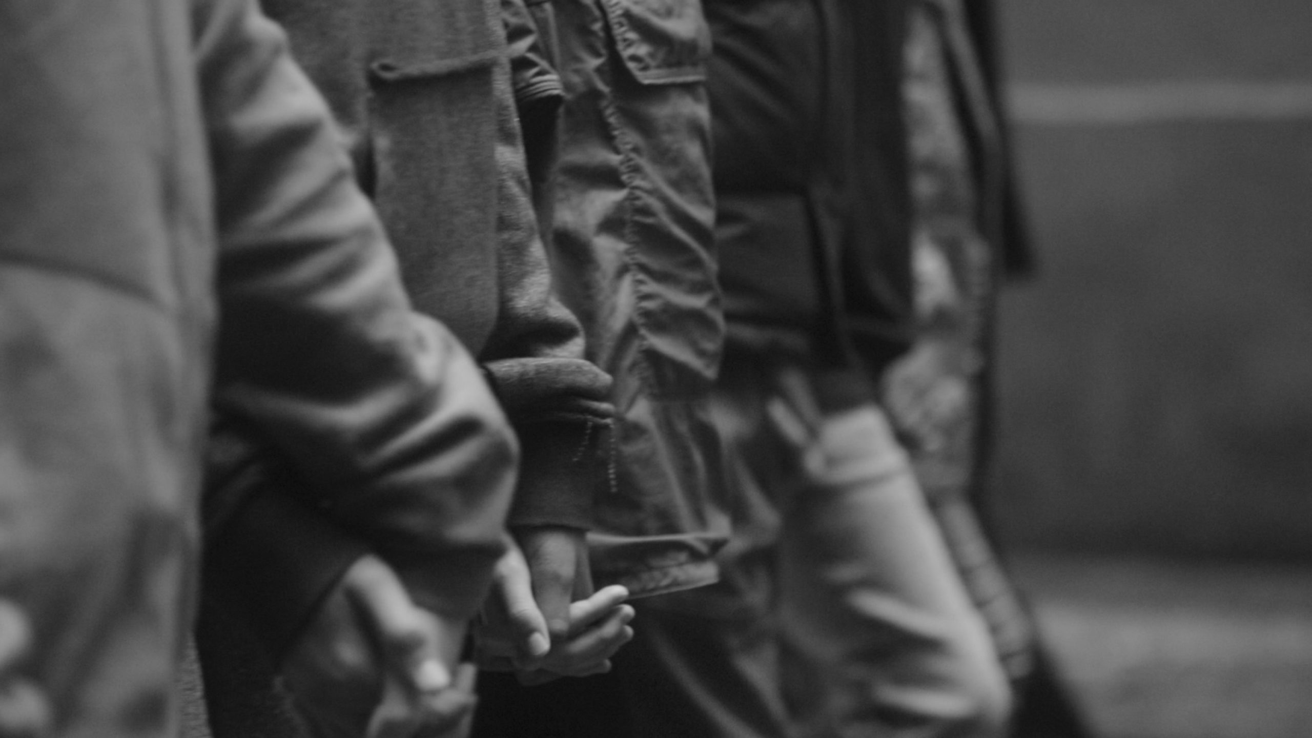 IU C&I Studios Page blackpac Closeup black and white midsection of a group of people in a line holding hands