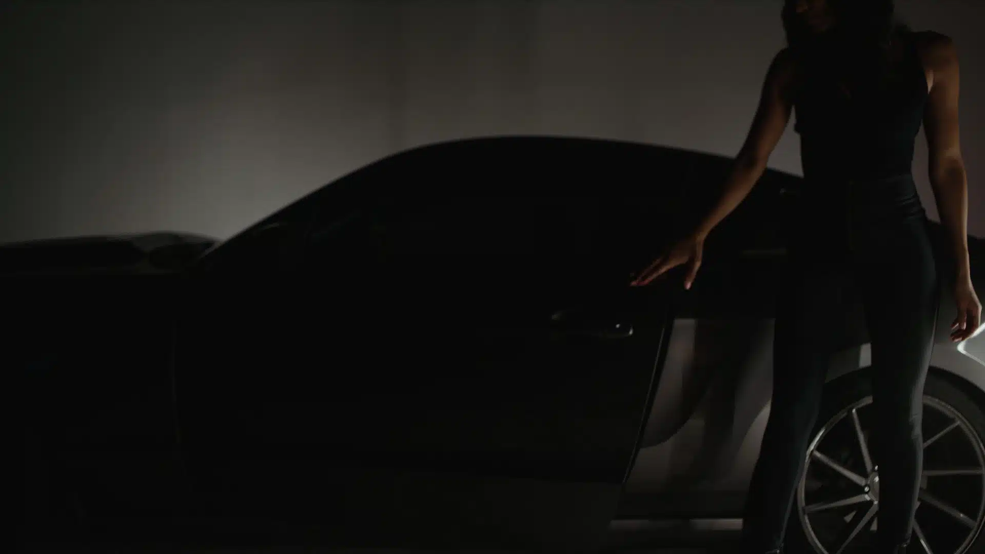 IU C&I Studios Page Garys Car Woman standing next to car with door open in semidarkness