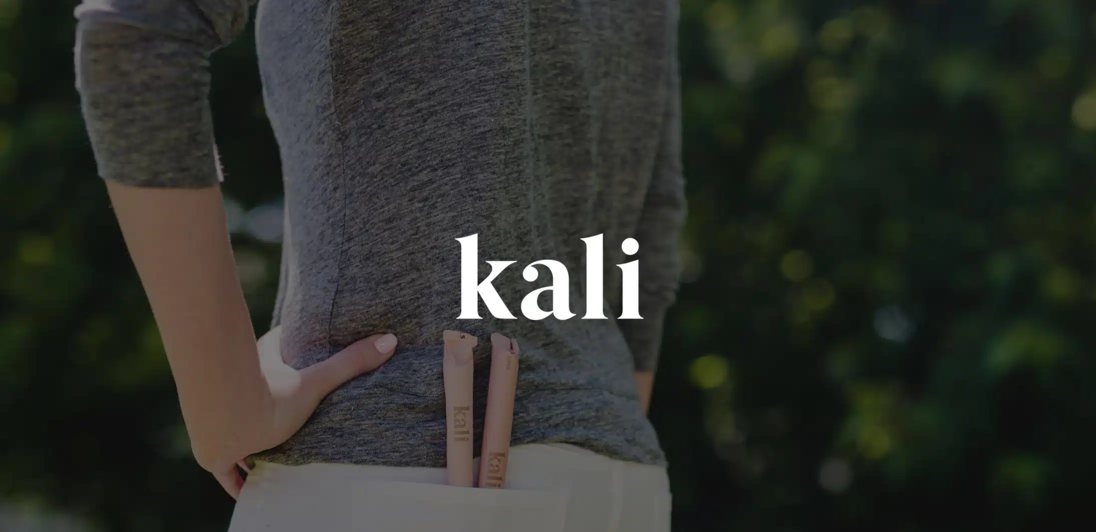 IU C&I Studios Page White Kali logo on dimmed background closeup of backside of woman with two tampons in her back pocket of her white jeans