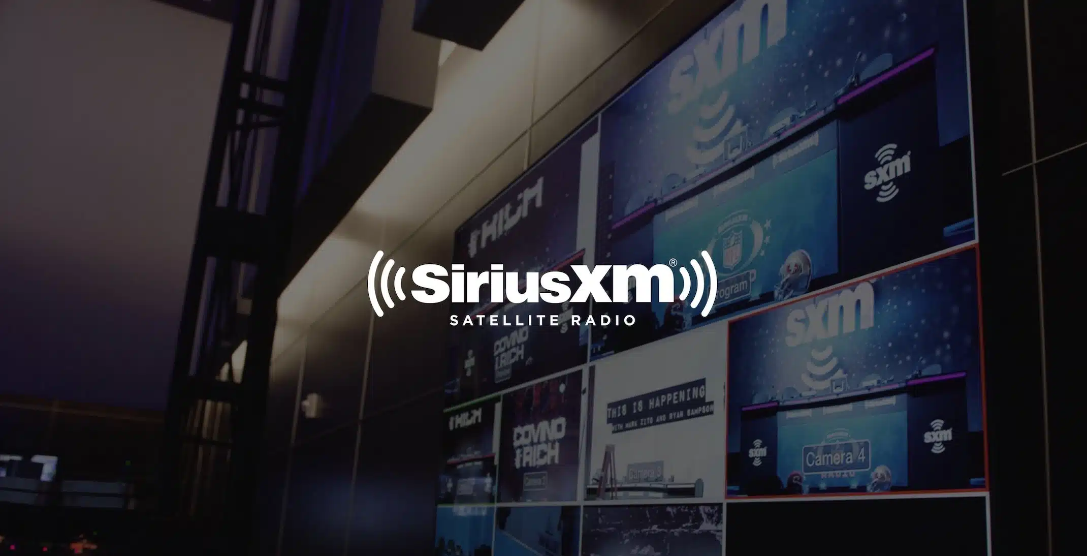 White Sirius XM Satellite Radio logo with dimmed background of video bank. Live streaming