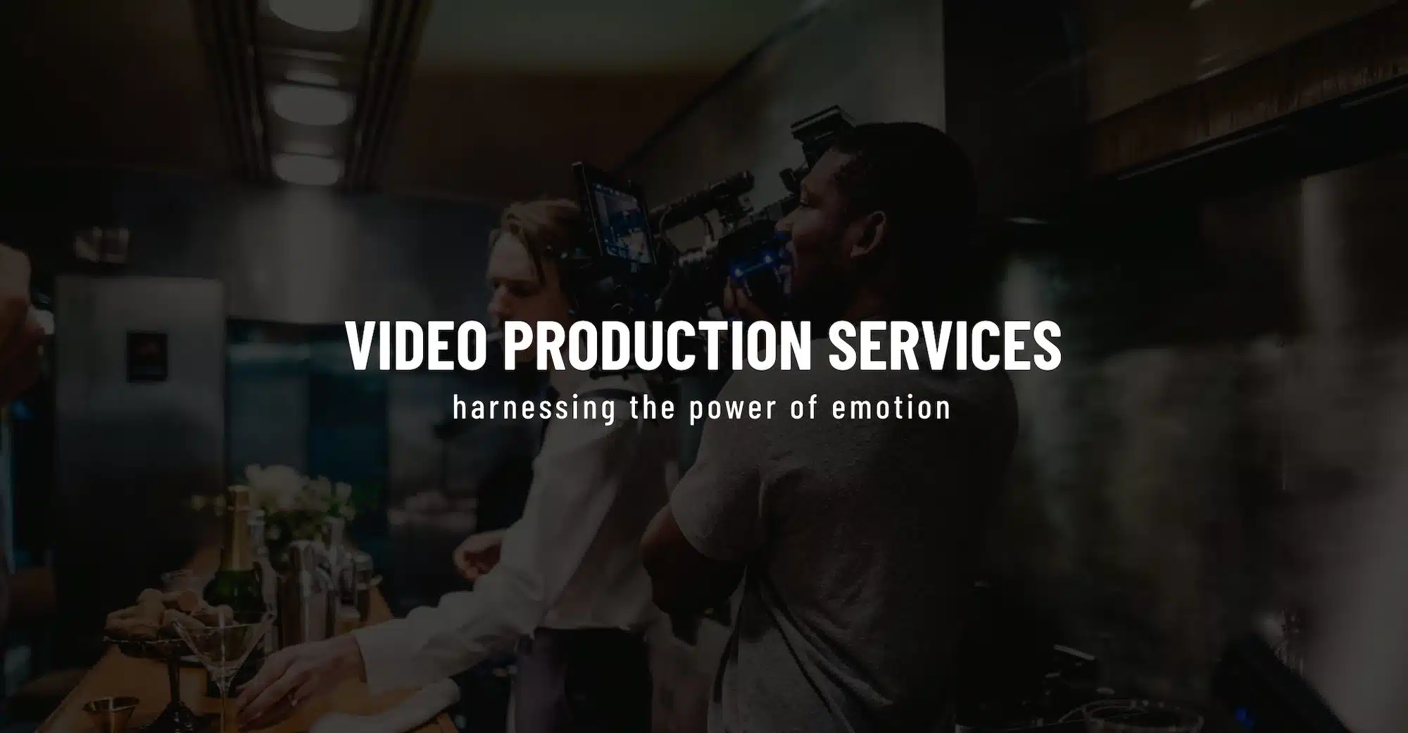 Keyword: Web Development .White Video Production Services title Creative Marketing Services by C&I Studios on dimmed background side profile of videographer filming bartender in a train car