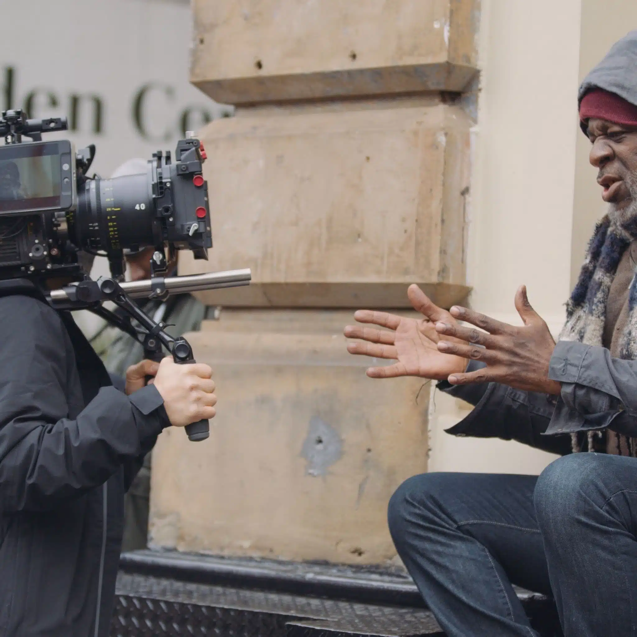 The Future of Production ALEXA Mini LF Side profile of African American actor talking being filmed by a video cameraman