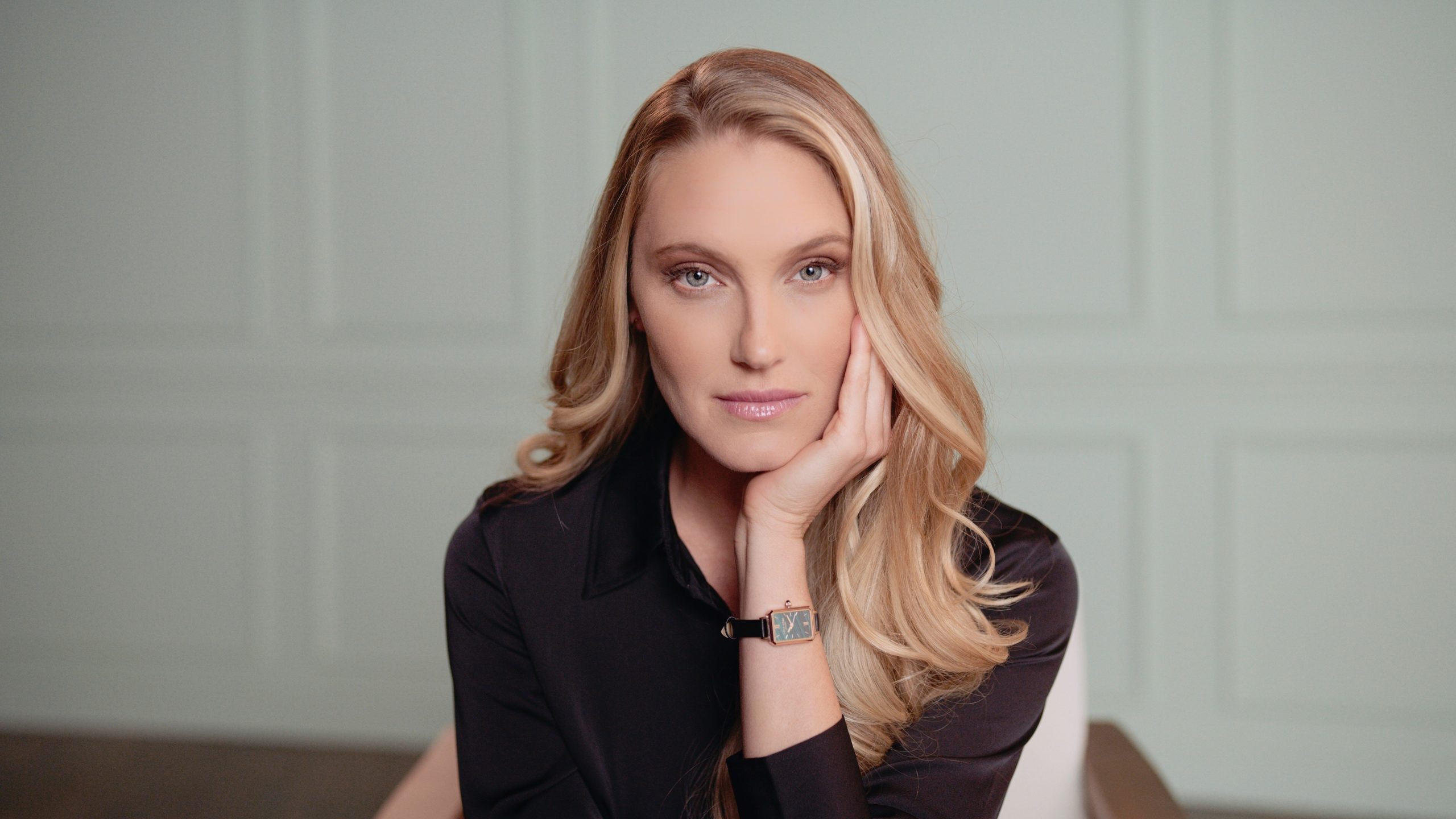 Lola Rose Headshot of woman with long blond hair posing for the camera wearing a watch