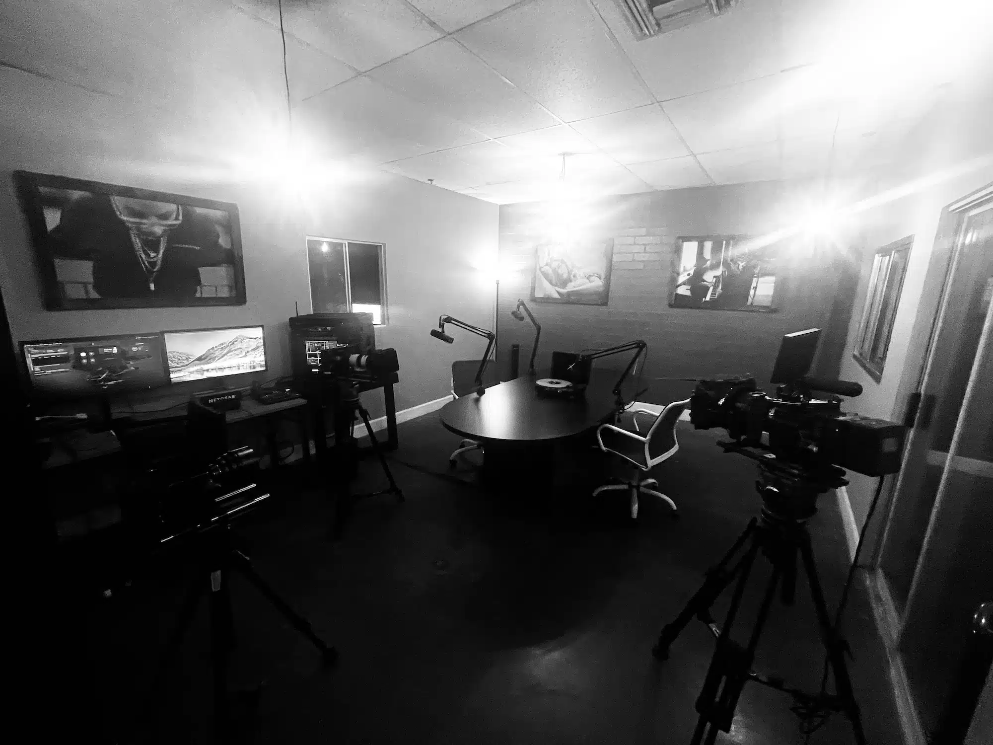 Black and white of LA Podcast Studio with video and audio equipment in a room