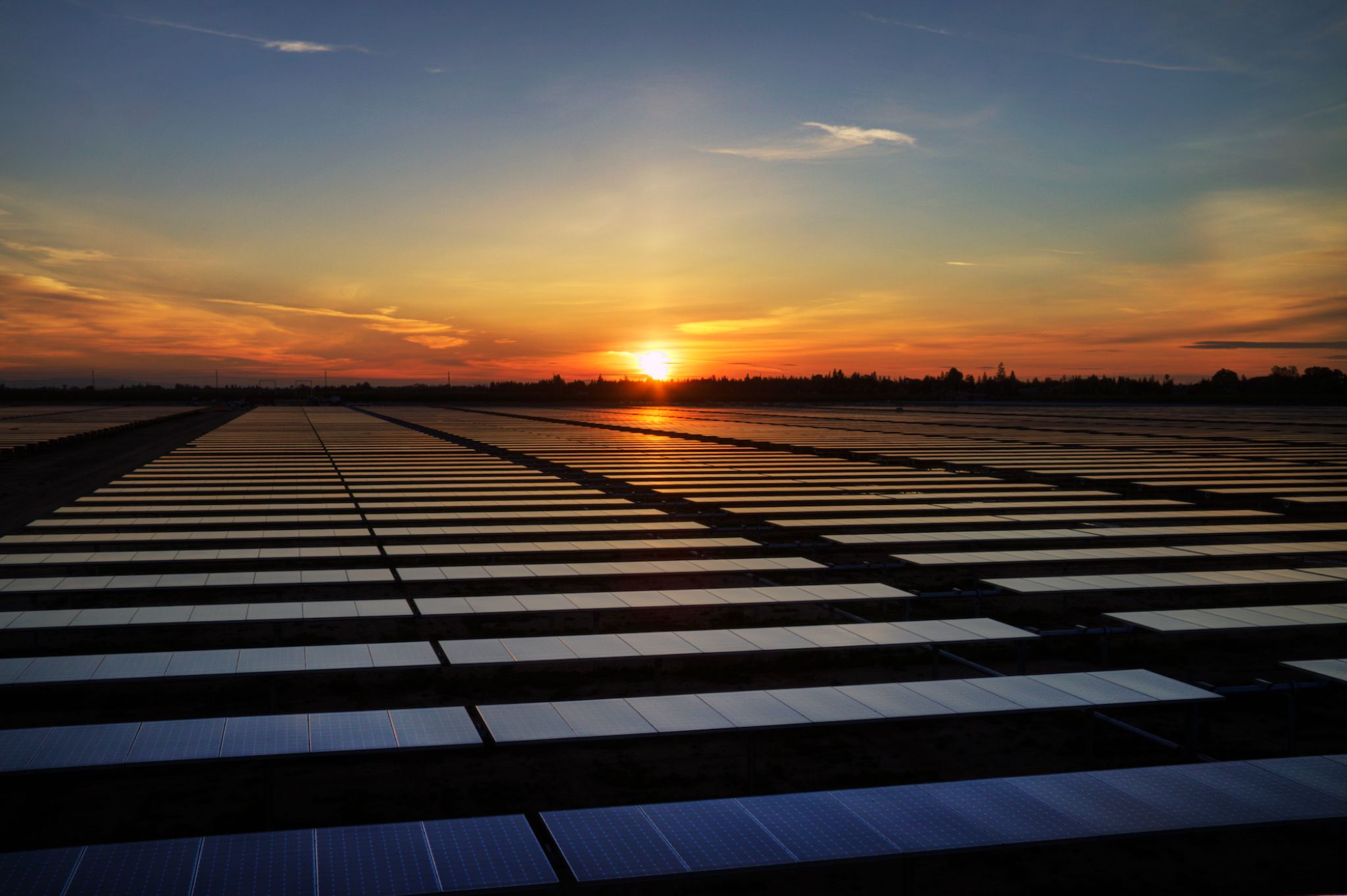 Aerial view of solar panels at sunset
