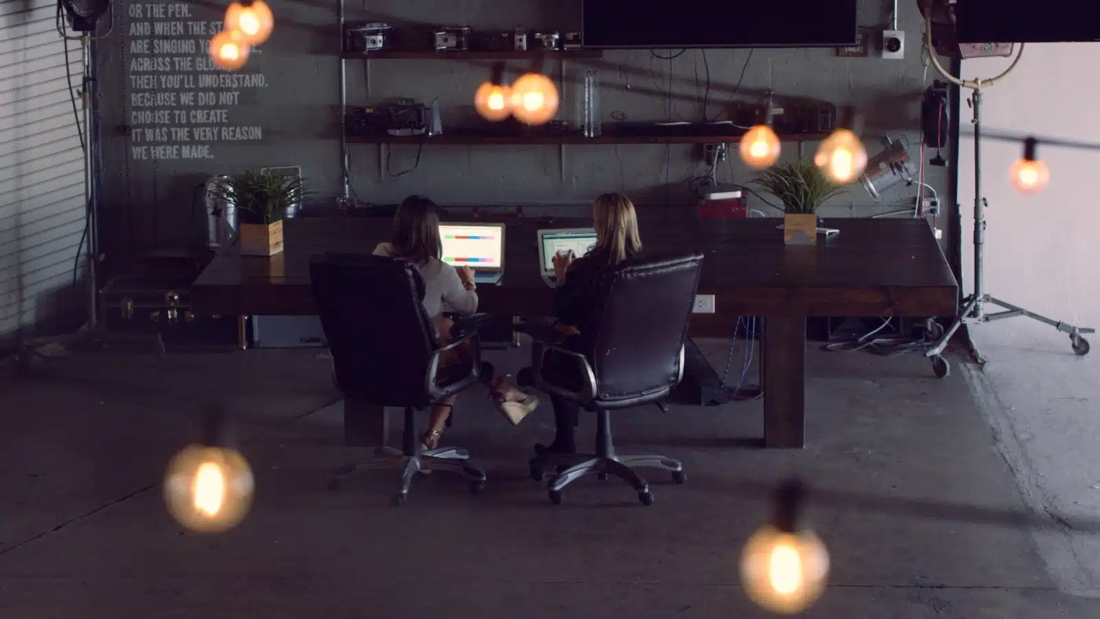 Brand Film View from behind of two women working on desktops in a studio