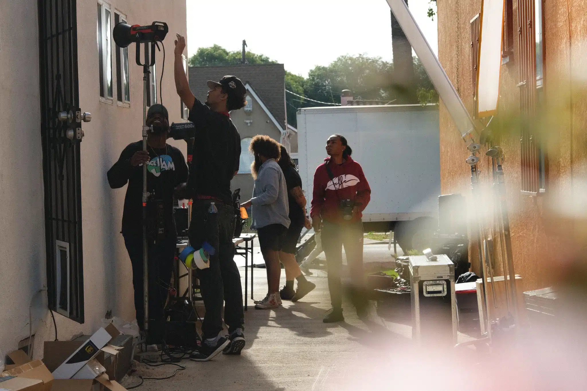 What Makes a Good Grip Male and female crew members setting up a set with equipment