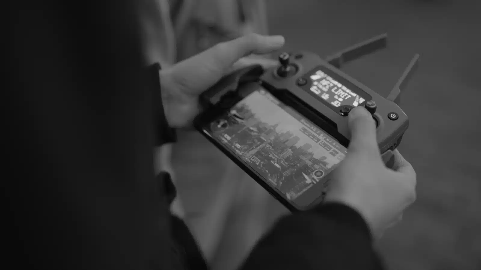 What makes a good drone operator Black and white closeup of a drone controller with video display being used